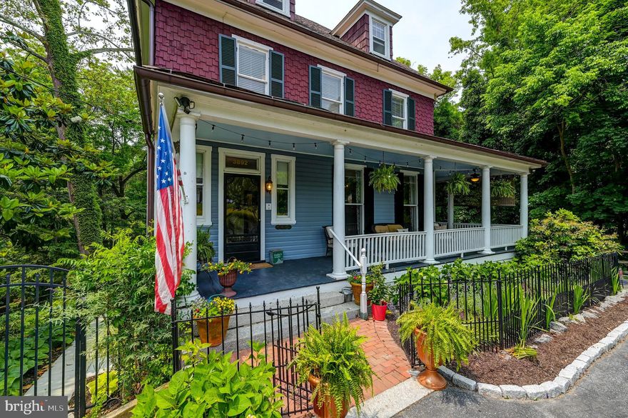A Farmhouse Fancy in Historic Ellicott City!  The site of many a winter holiday celebration gathering and oh, so many summer garden parties, this rare beauty provides the balance between house and property that few can match.  From its covered and wrap-around front porch to its massive rear deck and lush 1.7-acre fenced landscape, thought, care, and attention are evident.  Four finished interior levels provide abundance and versatility with decades of family history and countless hours of tender loving care and improvement beaming from room to room.  A chef’s kitchen sparkles with updated features, including quartz counters, glass cabinetry, and stainless-steel appliances. Each bathroom has been touched with specialty fixtures, millwork, and tile.  An open main level floor plan makes entertaining a breeze, while a quaint enclosed porch provides intimacy.    Each of the home’s five bedrooms is spacious and offers morning or afternoon sun.   A second-floor laundry center and a third-floor office with a wet bar are among the pleasant floor plan surprises, and a finished ground-floor suite highlighted by a cozy family room, den, bedroom, and full bathroom make this home full of opportunity.  Add partially covered and open brick patios,a screened porch, an outdoor shower, a hot tub, a pergola, and a detached two-car garage along with updated home systems, including a recent furnace and water heater, and this home is sure to bring your five-star review!