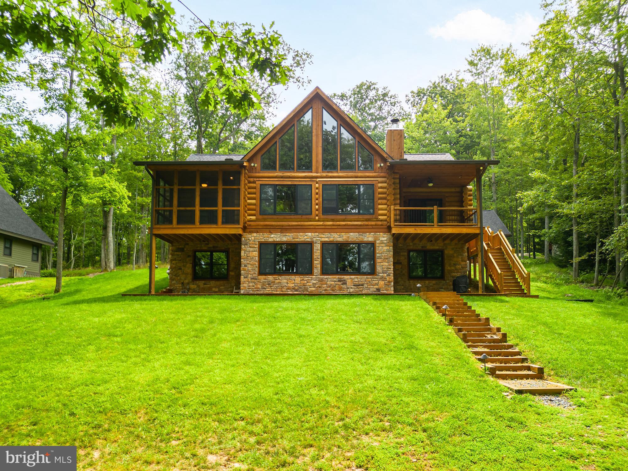 This stunning log home is situated in the sought after community of Thousand Acres. The neighborhood feels very private from the moment you drive in. The home offers three levels of living space, a main floor master, hardwood floors, spacious loft and granite countertops. The great room boasts a stone fireplace for you to enjoy on cool Garrett County evenings. An abundance of windows brings the outside in during any season, no matter which window you look out, the views are breathtaking. The three decks, one of which is screened, offers many options for your outside enjoyment. You'll love the convenience of the two-car detached garage, generator, plus a paved driveway. If all this isn't enough, let's walk down to the lake to enjoy your 100' of lakefront and private type A dock. Just around the corner is the ever-popular Thousand Acres Golf Club. Short term rentals are not permitted here, making this community even more quiet and private. Call today to preview this lakefront gem!