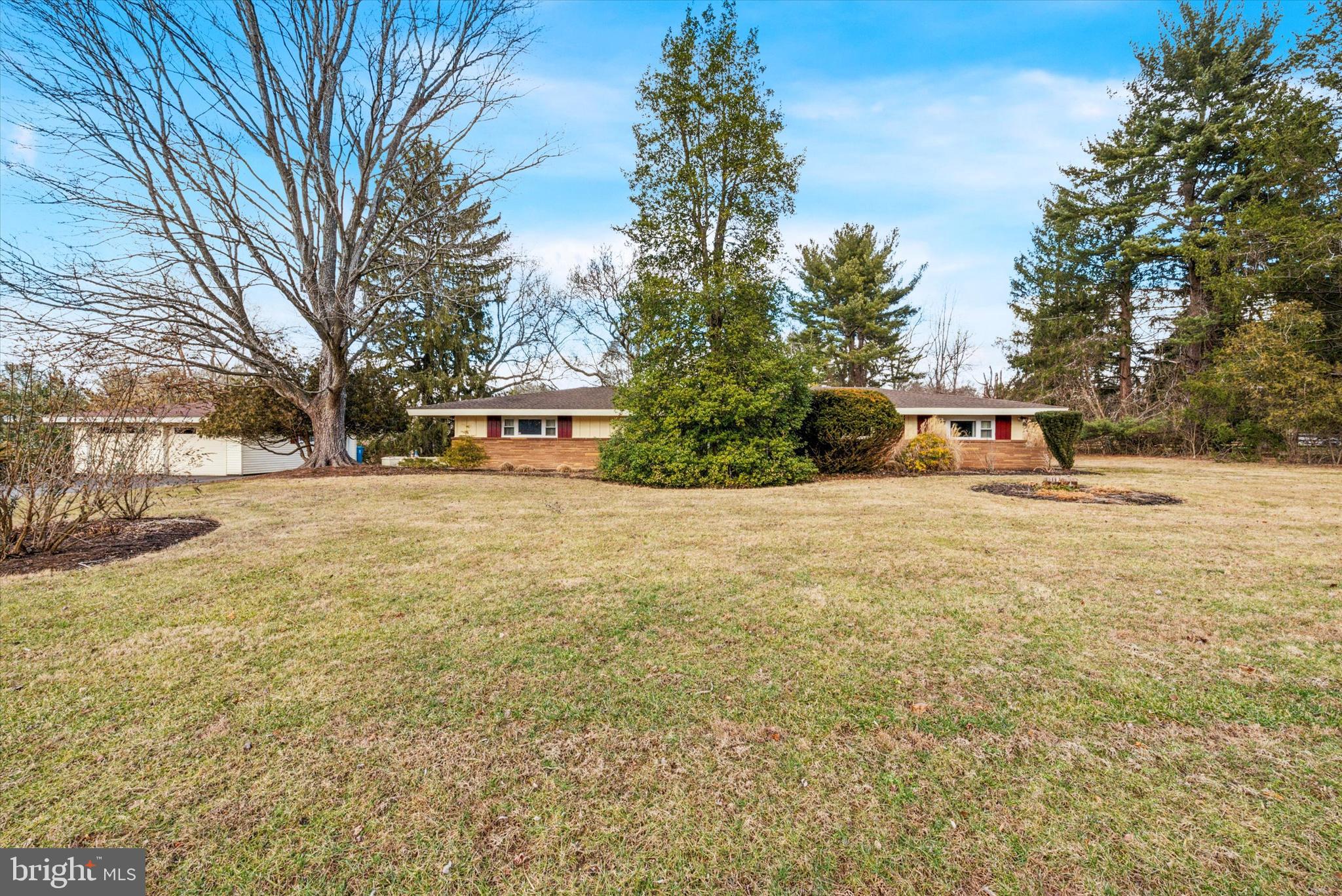 4 bedroom and 2 1/2-bathroom Ranch home in Kennett Square. Home is 2300 SQFT and has been well maintained and updated as needed. Gorgeous landscaped 1.9 acre lot, with great views! One floor living! Large windows and wonderful views of the outdoors all year around. Open living room and dining room, great for entertaining! Living room and dining room with vaulted ceiling and exposed beams. Stone corner fireplace. Dining room has door to rear yard. Large kitchen with plenty of cabinets and counter space. Breakfast bar and also more cabinets and pantry for more storage. Largr family room with half bathroom. Great for entertaining! Door from family room leads to patio and detached 2 car garage. Master bedroom with master bathroom. Master bathroom has stall shower. Large 2nd and 3rd bedroom. 4th bedroom currently used as rec room and office.(4th bedroom has space heater, but could add split unit. For heating and a/c in that room) Hall bathroom with tub shower. Laundry room with plenty of storage and 2nd refrigerator. Bonus room 8x7 used as storage room now. Previous owner used it as darkroom. Can be office or exercise room, etc. Detached oversized 2 car garage with electric garage door opener. Also room for storage and loft area. Larger driveway with plenty of parking. Paver patio with built in planter boxes. Professionally landscaped yard. New roof 2013. New house backup generator(propane) 2024. New well pump & electric box 2024. Septic system emptied and serviced 12/24. Heater and central air serviced every year. Home security system. Washer, dryer, and 2 refrigerators included! Home has 2 attics for storage. One has pull down steps and has floor. Home is on dead end street, great location! Home is within a mile of Longwood Gardens and Kennett Square.
