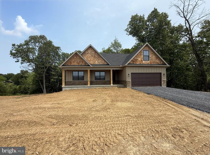 Welcome to this beautifully crafted 3-bedroom, 2-bath rancher nestled on 2 serene, partially cleared acres in a peaceful community where homes are thoughtfully spaced for privacy and tranquility. This exceptional property offers a perfect blend of comfort, style, and functionality, featuring an open-concept layout with upgraded luxury vinyl plank (LVP) flooring throughout, elegant wainscoting, recessed lighting, raised panel doors, and a versatile loft space upstairs—ideal for a guest suite, office, or playroom. The heart of the home is the stunning kitchen, complete with granite countertops, a large island perfect for entertaining, stainless-steel appliances, and white soft-close cabinetry. Just off the kitchen, unwind in the inviting living area or step outside to the cozy front porch and soak in breathtaking mountain views. The spacious primary suite offers two closets, a luxurious soaking tub with decorative tile surround, and a walk-in tile shower. Two additional bedrooms on the main level are generously sized, and the functional mudroom/laundry area off the attached 2-car garage adds convenience to everyday living. The exterior is SHOWSTOPPER- equally impressive, boasting board and batten siding on the front with cedar shake gables, a stone water table, eye-catching black windows s, and a walk-out basement with rough-in plumbing—ready for your future expansion.10x14 Back Deck & Sidewalk to be complete by the end of the week!Well & Septic. Located less than 20 minutes from Cacapon Resort State Park, where you can enjoy golfing, fishing, swimming, hiking, and more, and just a short drive to downtown Berkeley Springs with its charming shops, restaurants, and local amenities.
Don't miss the chance to make this stunning home your private escape in the heart of West Virginia’s natural beauty! 10x14 Back Deck & Sidewalk to be complete by the end of the week!