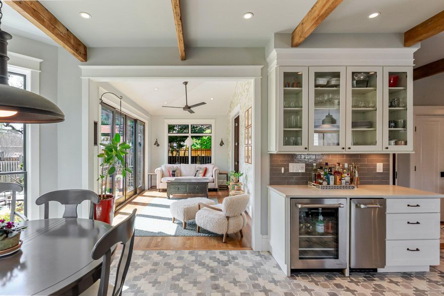 Featured on the cover of This Old House Magazine, this exceptional 1925 Craftsman in the heart of AU Park is a rare example of a home that honors its past while living beautifully in the present. Thoughtfully renovated with a designer's eye, it showcases original chestnut millwork, classic Craftsman detailing, and preserved period character—seamlessly paired with modern updates that enhance light, flow, and everyday livability. A short video is included with the listing, offering a series of visual highlights—be sure to click the video link to view.

Spanning four levels, the home offers both elegance and flexibility. The main level features a gracious living room anchored by a wood-burning fireplace, a formal dining room, and an expanded eat-in kitchen with a bright breakfast nook. A rear sunroom overlooking the garden, open to the breakfast area, adds an inviting, light-filled space, along with a convenient powder room.

Upstairs, the second level includes a well-appointed primary suite with a walk-in closet and en-suite bath with radiant heated floors, an additional bedroom and hall bath, and a den or home office, along with a full-size washer/dryer. The top floor offers two additional bedrooms and a full bath—ideal for family or guests seeking privacy.

The fully finished lower level provides exceptional versatility, complete with a private entrance, kitchenette, full bath, heated floors throughout, and its own washer/dryer—perfect as an in-law suite, au pair quarters, or potential income-producing space. A spacious recreation room adds even more flexibility.

Natural light fills the rear of the home, where the sunroom—converted from a screened porch and thoughtfully cantilevered—opens to a private patio. Throughout, smart architectural changes—from the relocated front door to widened openings with French doors—enhance flow and functionality. Ample storage is found on every level.

Ideally located in AU Park, the home offers easy access to the Red Line, Rock Creek Park, and the shops and dining along Wisconsin and Connecticut Avenues, all within a charming, tree-lined neighborhood. The beloved Millie’s is just a 5-minute walk away.

A home with this level of character, craftsmanship, and thoughtful updating is truly rare.