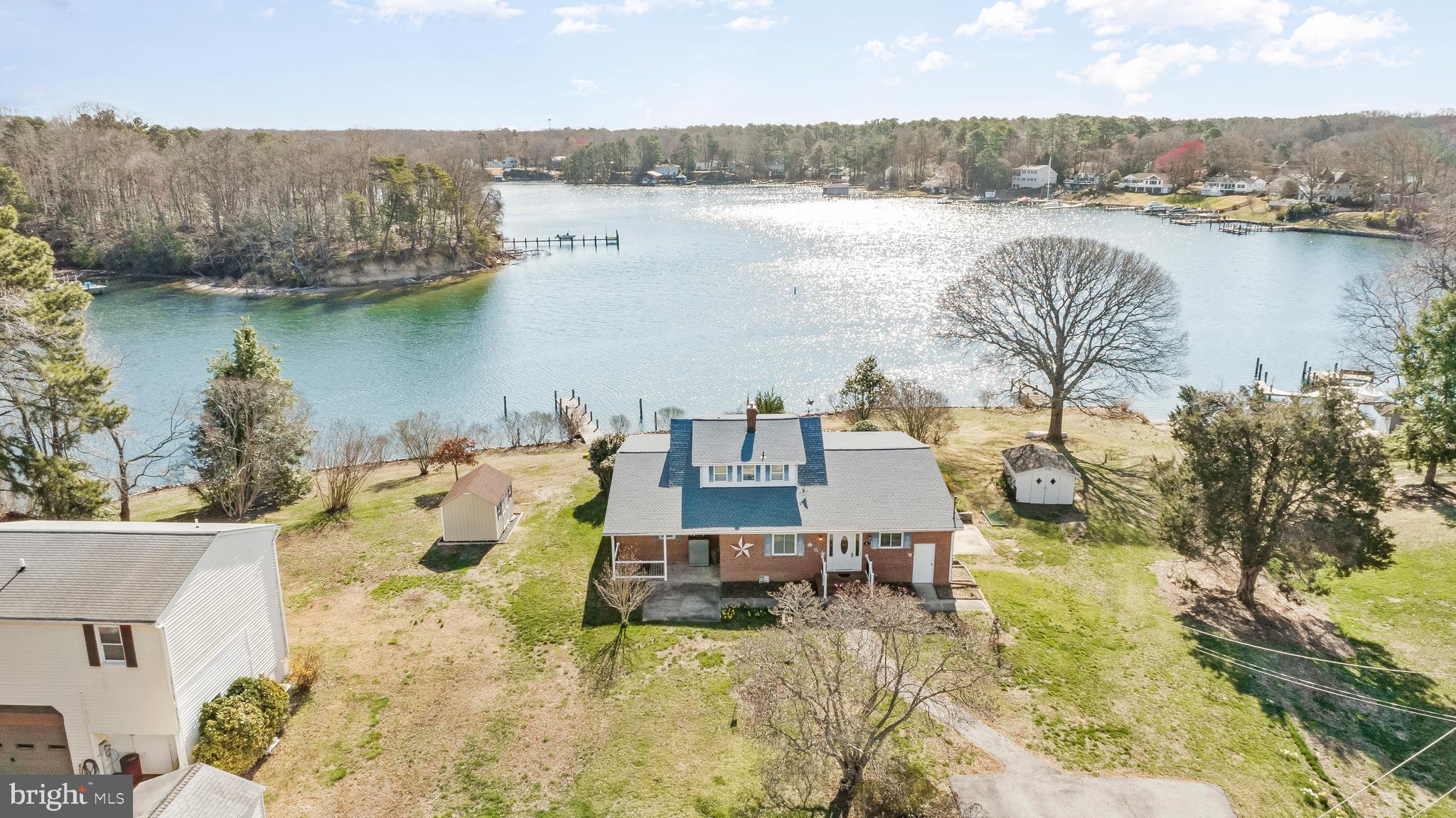 ***OPEN HOUSE - Thursday, March 27, 4pm-6pm**
LOCATION! LOCATION! LOCATION! Waterviews abound from practically every part of this beautiful 1.21-acre property with 449' of Frontage & 10'+ Water Depth on Mill Creek. The frontage is ripped rapped and boasts 2 private piers, each with deep water, and a private boat ramp! This is the perfect lot/location!
As you approach the home, you'll notice a spacious driveway with ample parking and scenic views of Mill Creek. Step onto the front porch and into the welcoming foyer—an ideal space to greet family and friends. To the right, you’ll find a convenient laundry room, and to the left, a nicely sized kitchen featuring a brand-new refrigerator and stove.
Flowing back through the kitchen, you’ll enter the generous dining room, offering plenty of space for a full dining set and perfect for hosting while your guests enjoy glimpses of the water. Beyond the dining area lies a spacious living room, highlighted by expansive views of Mill Creek. Just off the living room is a charming sunroom—likely to become your favorite spot in the house—where you can soak in the stunning sunsets and peaceful waterfront views.
Down the main hallway, you’ll find a large hall bathroom that serves the main floor including the second bedroom. The primary suite is complete with an ensuite bath, walk-in closet, and, of course, more water views. A second bedroom is conveniently located nearby for guests. Upstairs features a third bedroom, another full bath, and a large family room with breathtaking views of the water, along with a galley-style kitchenette—ideal for added comfort or guest use.
The partially finished basement offers great potential for storage, a recreation room, or anything else you envision. Outside, the property includes two sheds, mature trees, and a spacious yard ready for your landscaping dreams.
Additional features of this special home include a newly encapsulated crawlspace, newer septic system with BAT system, new oil tank, generator hookup at the panel, new attic insulation, new crawlspace insulation, and a brand-new roof installed last year. Original oak floors add warmth and charm throughout the home.
****We have verified via the Calvert County Health Department that the existing septic system is approved for up to 3999 finished sqft. This property is the perfect candidate for a remodel or small addition. 3,000+ modernized sqft in this location with the character of this lot would result in a value +/- $1,500,000!! Put your touches on this home and pick up some upside along the way!!***
No interior photos are provided at this time due to the interior being staged for an upcoming estate sale.
This waterfront gem is truly special and priced to sell—don’t miss your opportunity. Schedule your private showing today!