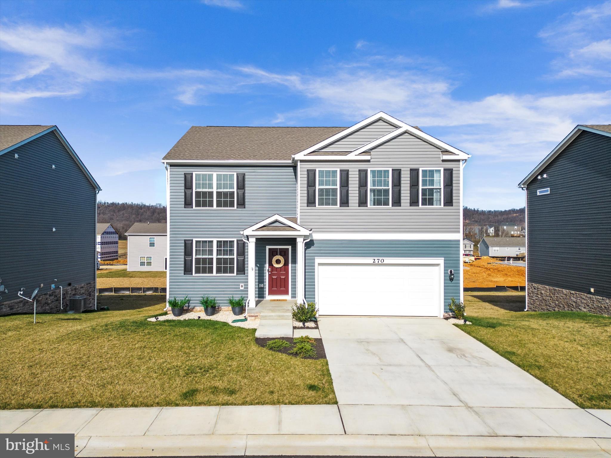 Stunning brand new home in the growing Red Hill community featuring over 2,800 sq ft of finished living space! There's no need to wait for new construction when this one is ready to go and has been enhanced with modern landscaping, a deck for outdoor living, stylish kitchen cabinet hardware, and tasteful ceiling fans for added comfort. This 5-bedroom home features a bedroom and full bath on the main level -- ideal for guests, a home office, or a kids playroom -- plus 4 additional bedrooms on the upper floor. There's also an open loft upstairs and another bonus space at the front of the home, providing even more flexibility. Enjoy the luxury of an open concept floor plan complete with a modern white kitchen and additional space provided by a partially finished walk-out basement. LVP flooring, granite counters in the kitchen and baths, and tall ceilings elevate the overall look and feel of this beautiful residence. Experience the perfect blend of sophistication and convenience just minutes from great shopping, dining, and commuter routes. Plus, rest easy with a builder warranty valid through June 2024. Don't miss out on the opportunity to see this amazing property. Your dream home awaits!