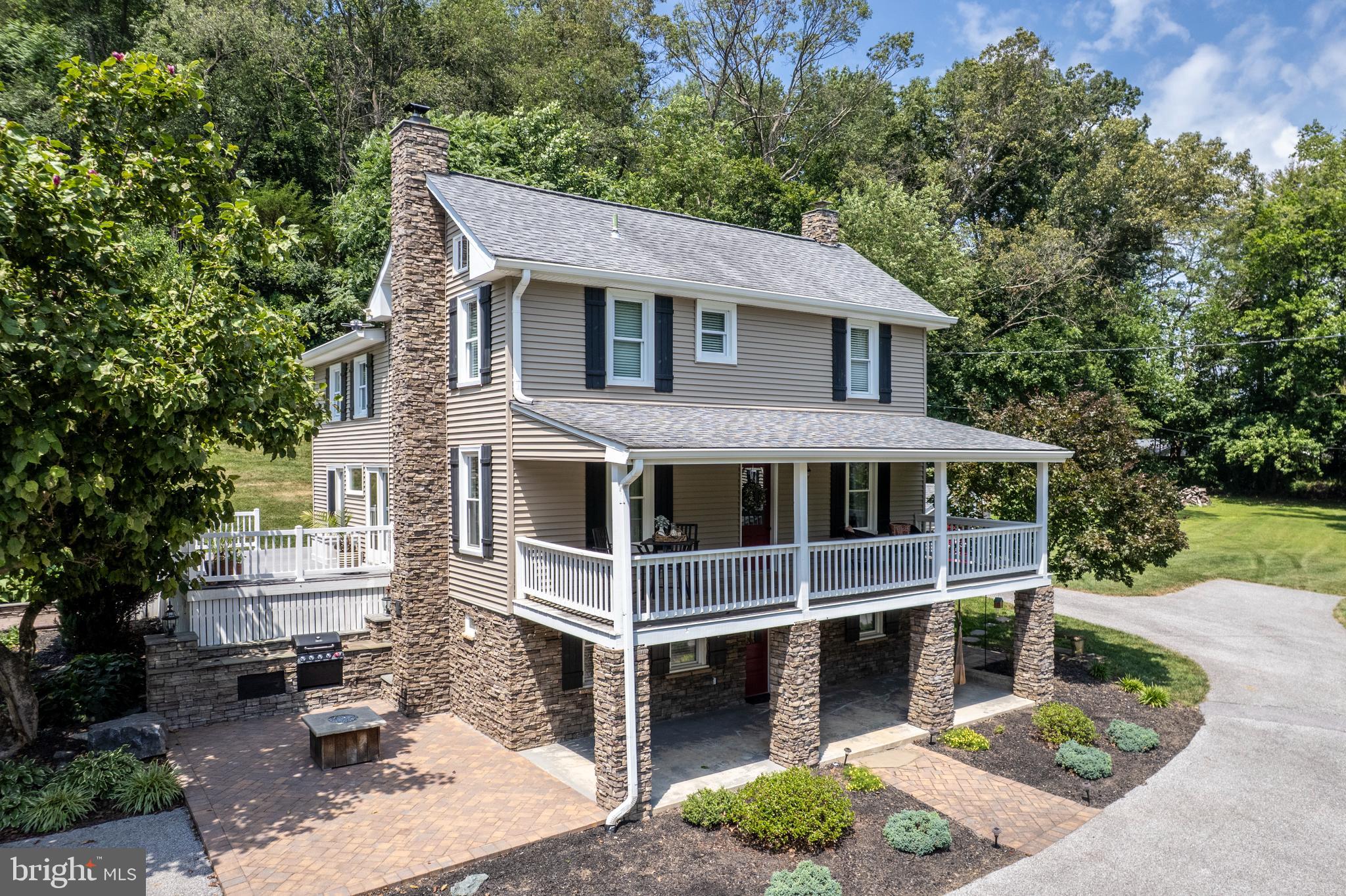 Beautifully updated 4-bedroom, 2.5 bath farmhouse offers the perfect blend of original charm and modern upgrades on 4.81 acres. The high-end kitchen remodel features a center island, stone backsplash, granite countertops, stainless appliances, a glass display cabinet, and exposed beams. Flooded with natural light, the eat-in area of the kitchen has 2 sets of sliding doors that lead to the side deck, and an outside kitchen that's ideal for everyday living and entertaining.
Upstairs, you will find four bedrooms and a convenient laundry area, along with a fully remodeled bathroom featuring ceramic tile, heated floors, and a jacuzzi tub. Some special touches include exposed walls, barn doors, maintenance-free railings, extensive hardscape and stone work, and beautiful landscaping.
The 25 x 50 detached garage is a standout, complete with a loft, rock climbing wall (including safety gear), basketball hoop, concrete floor, wood stove, electricity, and workshop area.
This one-of-a-kind property offers charm and character with well-thought-out upgrades, and is a nature lover's retreat with a peaceful stream, partially restored log cabin, extensive outdoor kitchen and patio, covered Gazebo, and so much more!
