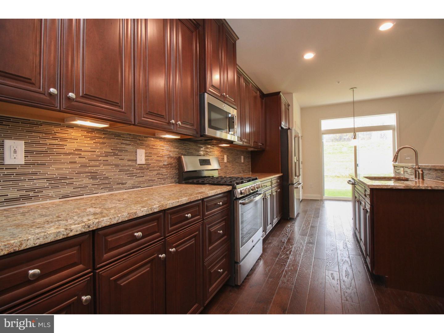 Newly built townhome with a dramatic 2-story great room, formal living and dining rooms and a gorgeous kitchen! Beauty and convenience in all directions. The great room has a fireplace, soaring ceilings and 2 rows of windows, letting in an abundance of natural light. The kitchen is open to the great room and features rich, warm granite and upgraded cabinets with mood-setting under cabinet lighting and a designer back-splash. This kitchen has fantastic meal prep, storage, socializing and cooking space! Upstairs are 3 bedrooms including a spacious master suite with TWO walk-in closets and a spa-like master bath with 2 granite-topped vanities, elegant tile and a private water closet. Built-in USB ports in every room, roughed-in plumbing included in the basement for future finishing and a convenient second floor laundry room with enough space for shelving and storage. This home includes a refrigerator, washer and dryer, which is usually not included with new homes. This home is ready NOW and comes with a comprehensive warranty and all of the benefits of buying new construction. Byers Station features 2 clubhouses with swimming pools, fitness centers, gathering spaces, playgrounds and activities for all!