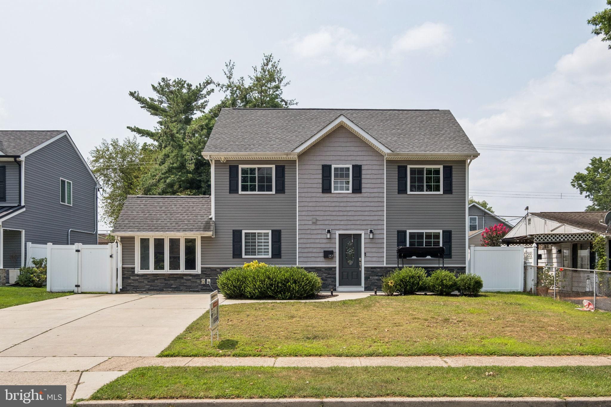 I cordially invite you to explore 137 North Park Drive in Bucks County, Levittown! This standalone property showcases an ultra modern display of crisp amenities and aesthetics that homebuyers are seeking today! Approach a beautiful concrete, stamped driveway along with a vibrant green landscape on all four sides! Enjoy the mornings out front on the perfectly sized patio. Enter into the property to be greeted by a display of neutral tones, flooring throughout the entire house, as well as a combination of chair rail and crown molding! The first floor offers an inviting space inclusive of the main living room, a beautiful open kitchen with a gorgeous gray slate of countertops with a waterfall edge, stainless steel appliances, as well as the rather spacious dining room and/or additional family room space if you so please! Off of this space is the laundry room, offering a ton of storage space as well as access to the rear yard. Finishing the first floor are two bedrooms, as well as a full bathroom, which offers a full shower and tub with the same beautiful display of aesthetics and modernization as seen thus far. Continue to explore upstairs and you will find a third bedroom with a gorgeous accent wall as well as the fourth and largest master bedroom with a huge walk-in closet. Finishing off the upper level is the second full bathroom, which offers a dual vanity, as well as a walk-in shower, finished with a tiled design and modern amenities as well. Your backyard parties and relaxation await you as you explore the outdoor space: including, but not limited to a beautiful deck, new hot tub, as well as a playground, and an oversized shed for all of your storage. This house has been meticulously maintained and is more than move in ready. Close to so much that Bucks County has to offer you as well as an easy commute to all major highways and roads of travel. Consider adding seeing 137 North Park Drive in Levittown to your list of properties today!