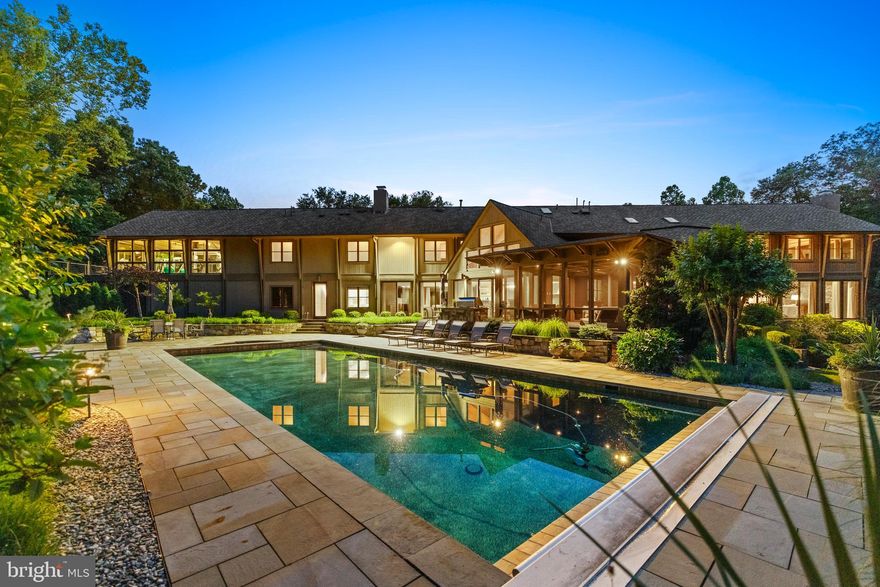 SELLERS WILL ACCEPT BACKUP OFFERS. PLEASE CONTACT LISTING AGENTS WITH QUESTIONS OR REQUESTS TO TOUR. Featured in the Washington Post, this architectural masterpiece elevates contemporary design to an entirely new level.  Evoking feelings of the finest western resort homes, this residence offers a stunning collaboration of wood, stone, glass and light. The luxurious custom home features an open floor plan, unparalleled finishes, main level primary wing with 2 private studies, newly renovated kitchen and baths, 900 sf fitness center, pool, spa, 6 car garage, private staff quarters, the list goes on and on...  With an impressive 11,000 sq. ft of living space on 2 private, professionally landscaped acres this home is truly special. An open floor plan offers a dramatic two-story great room with soaring beamed ceilings, wood burning fireplace, floor to ceiling windows, and spacious dining room overlooking manicured grounds. The newly renovated gourmet chef's kitchen features an expansive seated center island, premium appliances, and sun-filled breakfast area. Step into the family room with wood burning fireplace and walls of windows creating an inviting atmosphere for relaxation and entertainment. One of the highlights of the home is the serene screened porch perfect for unwinding at the end of the day. The main level primary wing features a luxurious primary suite with gas fireplace, private terrace and newly renovated spa bath as well as two offices providing a peaceful work from home space and quiet retreat. Upstairs you'll find 5 additional bedroom suites, renovated baths, a lounge area and show stopping 900 sf fitness center with private terrace. An expansive lower level offers a recreation room with game area, media area, craft and bonus rooms along with 3300sf of storage space. Entertain away in the backyard pool, spa, built in grill, playground, and generous yard surrounded by professionally landscaped grounds provide a delightful oasis. A private apartment over the garage offers the perfect quarters for inlaws, guests or staff.
Car enthusiasts will appreciate the 6-car garage ensuring your vehicles are housed in style. With meticulous attention to detail, this home offers a whole house generator, NEW and updated HVAC systems, updated water heaters and NEW roof. 
Don't miss the chance to live in unparalleled luxury combining the highest end post and beam construction and distinctive architecture with modern amenities. This home is truly special. Schedule your private showing today. 
Near Glenstone Museum, parks, hiking and biking trails and more.  
REGISTRATION FORM REQUIRED PRIOR TO SHOWING. PLEASE CONTACT CO-LISTING AGENT FOR FORM.