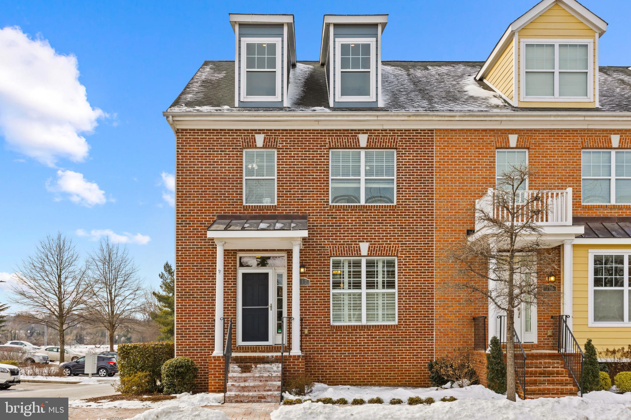 Discover this stunning luxury end-unit townhome in The Townes at Maryland Hall, offering over 3,300 square feet of beautifully designed living space across four fully finished levels. Built in 2012, this residence combines modern elegance with thoughtful upgrades, ensuring comfort and style.  In 2025, the home was freshly painted, featuring newly refinished hardwood floors and brand-new carpets. The main furnace and A/C were replaced in 2022, and a new mini-split unit was installed in the loft in 2025. An open floor plan greets you with a bright living room featuring a gas fireplace, wooden interior shutters, and ample natural light. The space seamlessly flows into a separate dining area and a gourmet kitchen, outfitted with white wood cabinetry, stainless steel appliances, granite countertops, and a central island with seating. A private deck off the kitchen completes the main living area. Additional details include crown molding, chair rail accents, beautiful hardwood floors, recessed lighting, and a convenient powder room.  The second level hosts a spacious primary suite with a large walk-in closet and a spa-inspired ensuite featuring a soaking tub, double vanity, and shower. Two generously sized bedrooms share a full hall bathroom, with easy access to the laundry area.  The third-level loft impresses with vaulted ceilings, abundant natural light, and versatility. It serves as a fourth bedroom with a private bathroom, making it ideal as a secondary primary suite or a flexible great room.  The finished basement is an entertainer’s dream, complete with a built-in bar, handcrafted three-piece slate pool table, and a 120-inch projector screen for movie nights or game days.  Positioned adjacent to Maryland Hall, Spa Creek, and the vibrant Annapolis Arts District, this home offers unbeatable convenience. Benefit from a private driveway and an additional assigned parking space for effortless living.  Enjoy quick access to Rt. 50 and all that Annapolis has to offer.  With an HOA that includes landscaping and snow removal, this home offers effortless living in a prime location.