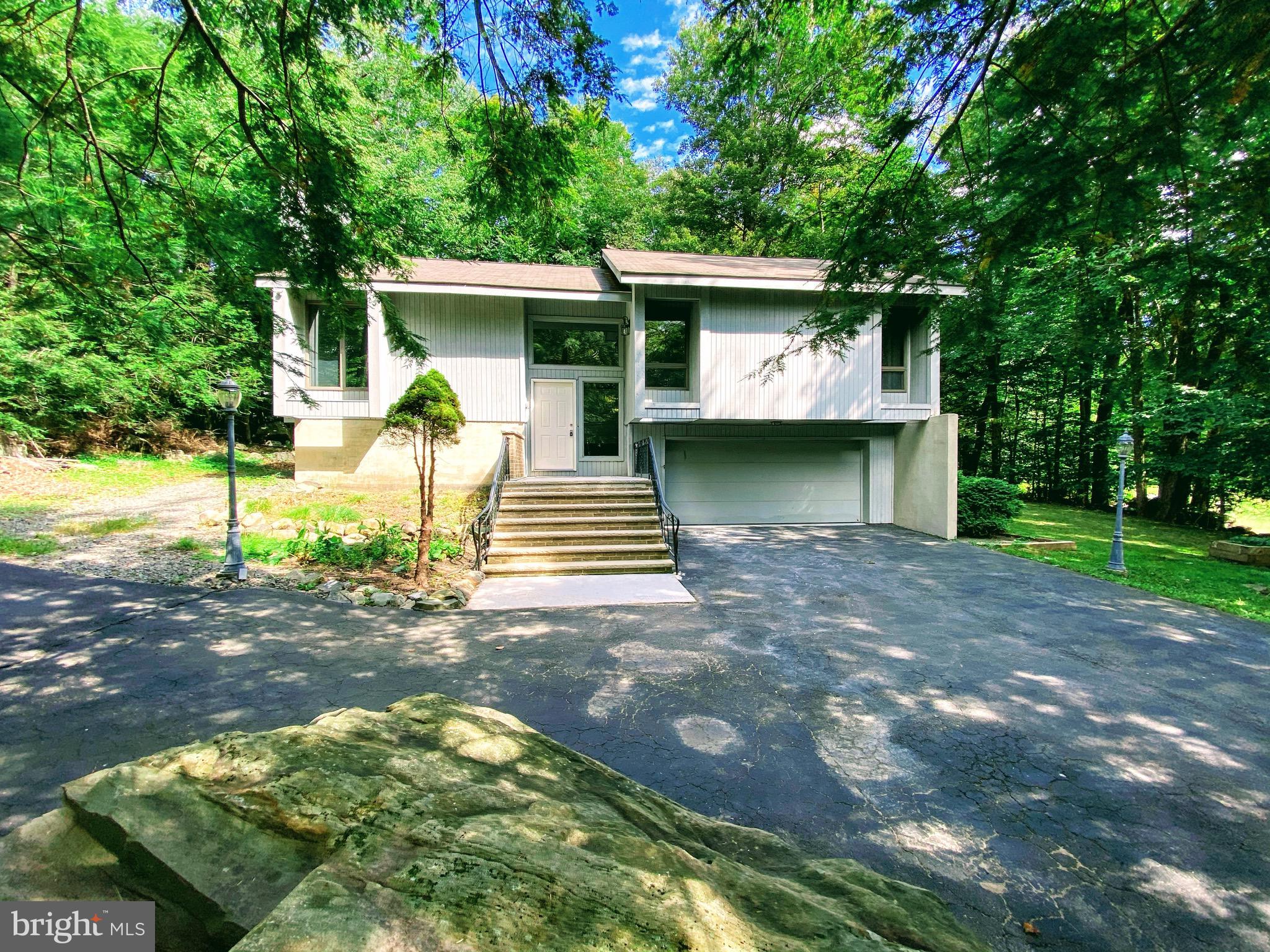 Located among a golf course, fishing spots and pools, tennis courts, water sport amenities. This modern, 3 bed 2.5 bath ,upgraded, and updated, split level home features, a wood burning fireplace in the living room, and a heated sunroom, with walkout to a full size deck, complete with a hot tub, perfect for entertaining guests! Hard flooring throughout the first floor, a master bedroom with full bath. Lots of storage space and closets. Lower level includes a walk out basement with additional bathroom and room. Comes with a complete home warranty at closing.