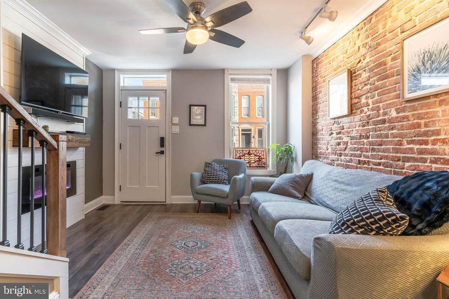 Steps to Riverside Park! Classic city charm meets thoughtful modern updates at 1720 Byrd St. This refreshed 2-bedroom, 1.5-bath brick townhome is tucked into Federal Hill, just steps from Riverside Park and surrounded by some of the area's best dining and neighborhood favorites. The home features brand-new flooring throughout and beautifully remodeled bathrooms completed within the last two years. The living space is cozy yet stylish, highlighted by a new electric fireplace, custom built-in shelving, and detailed custom trim that adds character and craftsmanship.  The kitchen leads to the back yard--perfect for BBQs or enjoying some urban green space. The back is fully fenced and had low-maintenance turf. Upstairs you'll find two spacious bedrooms, plus a full bath with custom tile and a glass shower door fora  spa-like feel.  The basement offers exceptional storage with a convenient bin wall system, keeping everything organized and out of sight. Easy access to the laundry makes this chore a breeze. With its timeless brick façade, move-in-ready updates, and unbeatable location near parks, restaurants, stadiums, attractions, and waterfront fun, this Federal Hill townhome is the perfect blend of comfort, style, and city living. Don't wait--schedule a visit now!