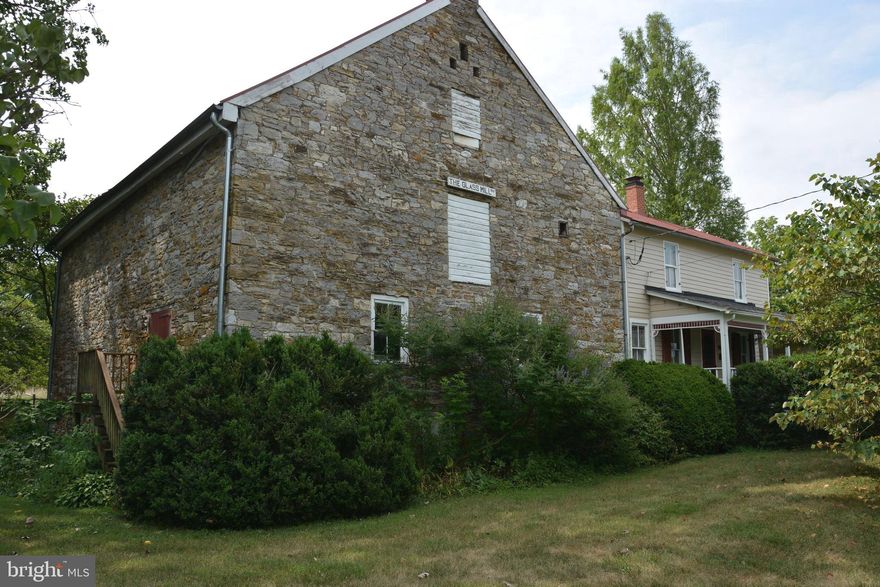 This is a unique opportunity to purchase a piece of history.  The Glass Mill (Glass/Rinker/Cooper Mill) is available.  The Mill was constructed during the years 1812-1815.  At the base, the structure has stone walls that are 3' thick, tapering to about half that at the gable ends.  The Mill has a "mechanics level", the lower level with dirt floor and water source when the Grist wheel was in place.  The next two levels are wide open with wood floors and open beams.  There are also stairs to attic space on the very upper level. The attached "miller's house" was added several decades later.  Still quite livable with original wood floors, formal living and dining rooms, and bedroom(s), bath, upstairs.  The interesting features remain.  The Mill office is off the living room, where the original wood burning fireplace remains. The house has a covered front porch, and rear upper and lower covered porches.  The grounds are quite nice with an array of plantings and a path/walking bridge over Opequon Creek.   This property is at the corner of Cedar Creek Grade and Miller Road.  There is no For Sale sign posted. Inquire about information relating to Deed of Gift Easement with Historical.