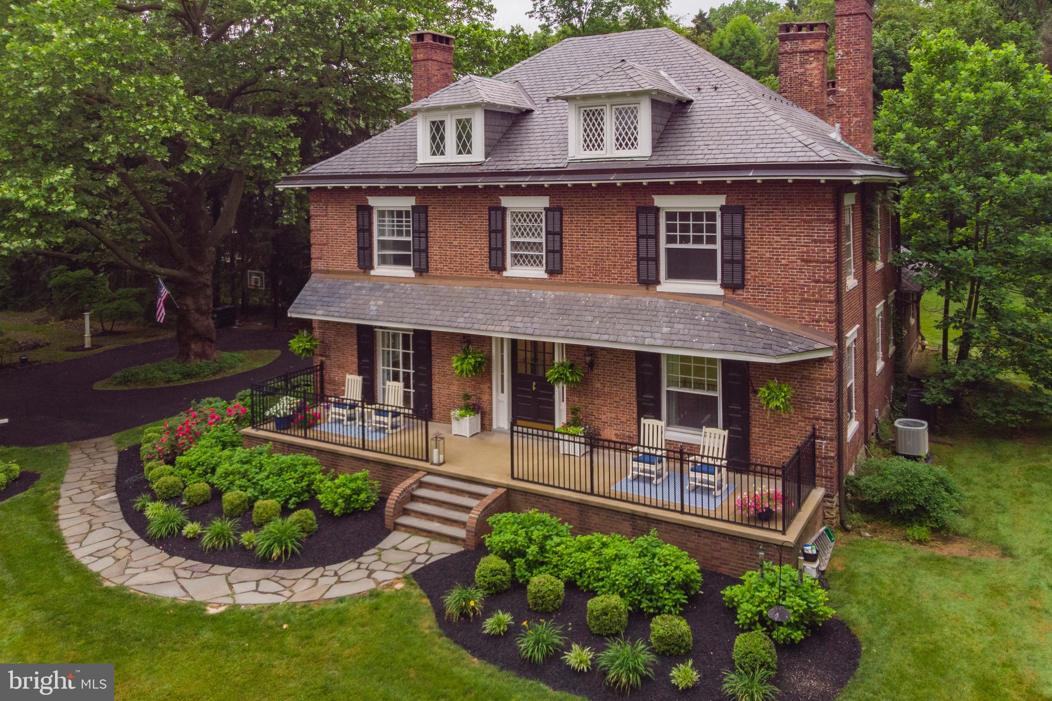 Welcome to 275 Foxhall Lane, this Classical Georgian Colonial exhibits details of Flemish bond brick exterior, hooded front entry, hipped roof with paired end chimneys and many other architectural features in doorways, cornices, windows, and mantels. Originally built in the early 1900’s as the Farmers house for the famed Cassatt Estate, currently the Upper Main Line YMCA, which is just a short walk through the woods by the bird sanctuary. This extraordinary property at the end of a coveted private lane with a long tree lined drive, offers the most idyllic setting of more than an acre of privacy, peace, and serenity. Upon entry you will be enchanted by this grand dame reminiscent of a by gone era of quality and craftmanship and appreciate how it has been lovingly restored and updated to delight today’s most discerning buyer. You will find all the refined hallmarks of a turn of the century home such as the high ceilings, rich wood flooring, millwork, built in shelving, crown moldings, and oversized windows which bathe the home in an abundance of natural light. The layout and natural flow of the first floor makes this magnificent home a stylish place to entertain. The large kitchen is a chef’s paradise, with state-of-the-art equipment, a large flowing granite island and step-down terrace, making it the perfect central hub of the home. Three levels of comfortable living, afford room for all. The second level includes four bedrooms, two full baths as well as the laundry and exercise room. The third floor includes three bedrooms and a full bath. The charming guest cottage offers a bedroom, bath and sitting room with a wood burning fireplace and kitchenette. This makes for a great home office, or nanny suite. This move in ready home, is in the top rated Tredyffrin-Easttown School District, and a short walk to the Upper Main Line YMCA, Daylesford Train Station, as well as the middle and high school.