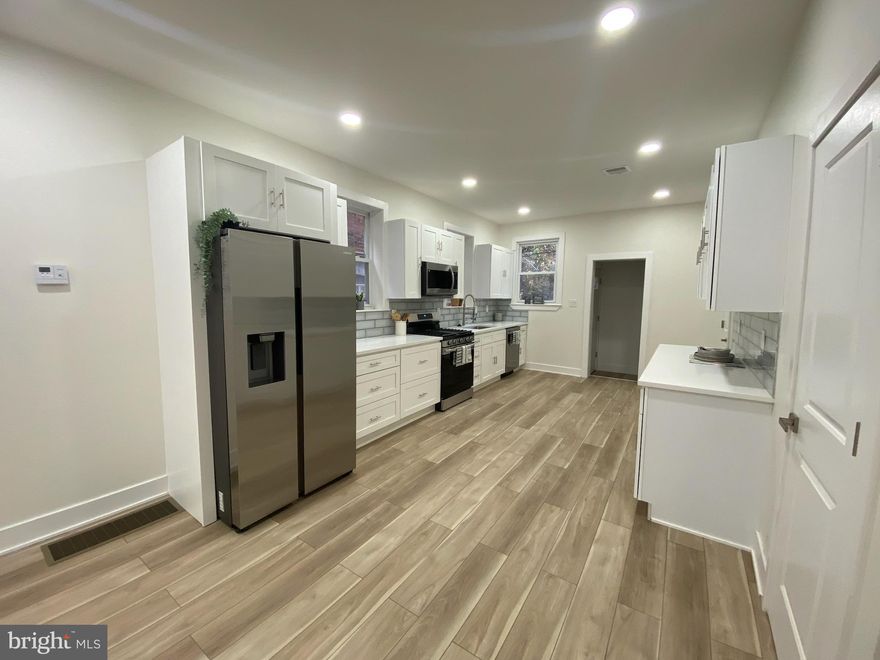 Welcome Home to this unique property. Enter the light-filled great room and enjoy the abundant open floor plan with recessed lighting, hardwood floors and a neutral color scheme throughout. The streamlined kitchen features soft-closing shaker cabinets and drawers, granite countertops, a glass tile backsplash, stainless steel appliances, all leading to the mud room and rear outdoor space. A pantry and convenient powder room completes this level. Upstairs is the primary suite and three generous bedrooms with a spacious hall bath. The primary suite features a private bathroom. All four bathrooms in the home feature custom tile work and vanities. The fully finished basement includes laundry hook-ups, a full bathroom, kitchenette and great room. This property offers exceptional amenities and is well situated.