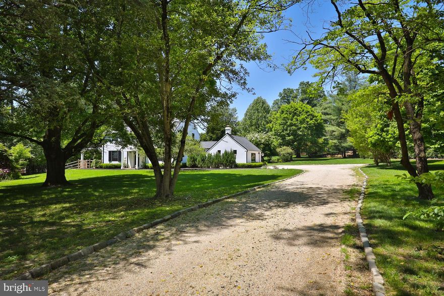 Welcome to this beautifully designed and updated 4-bedroom, 4-full bath country estate home that blends historic charm with modern luxury; set back on 2.68 acres of professionally designed and landscaped grounds in Flourtown, Springfield Township.
This home offers the perfect blend of tranquility, privacy and community.  It is located within the Top-Rated Springfield Township Public School District with the convenience of easy access to Chestnut Hill, Center City Philadelphia, Philadelphia Airport, and major Pennsylvania highways.  
The center of the home is the Great Room, where a beamed cottage-style ceiling and a hand-built stone fireplace, flanked by custom cabinetry, create a spacious and cozy gathering space for family and friends. The professional chef designed kitchen is a cook’s dream, featuring an expansive custom center island with white granite countertops, gas cooktop with a retractable vent, double ovens, farmhouse sink, large pantry, and coffee bar that includes wine storage with a large built-in fridge. The home features teak hardwood floors throughout and custom window treatments. 
Adjacent to the great room, through customs glass sliding doors, is a large bluestone patio that offers a serene space with uninterrupted views of the gardens of flowers and heritage trees.
The formal dining room overlooks the front gardens and leads to a second spacious living room with a second fireplace and large picture window overlooking the grounds.  This room has access to a covered porch with ceiling fans, ideal for three-season enjoyment. A large, fenced dog run adds convenience for pet owners.
Completing the first floor is an office/au pair suite/guest room with garden views, a full marble bath with heated floor, which can be easily added to the living room to create a larger private in-law suite with private entrance.
Every window and patio door in this light-filled home has been thoughtfully placed to offer expansive views of the spectacular grounds. A custom staircase, illuminated by a skylight and chandelier leads to the second floor.
The main bedroom, featuring a cottage-style ceiling, opens to a private deck and features a personal spa with heated floors, a 6-foot soaking tub and glass rainfall shower. Two additional bright and spacious bedrooms share a beautifully appointed marble bath, also with a heated floor.
The home includes a large, finished lower-level flex room with full bath, heated floors and built-in cabinets, perfect for a movie room, playroom, home gym or guest suite. In addition, there is a separate finished large laundry and storage room.  Finally, the attic space above the 2nd and 3rd bedroom is finished, insulated and well prepared for long term storage. Smart home security system.