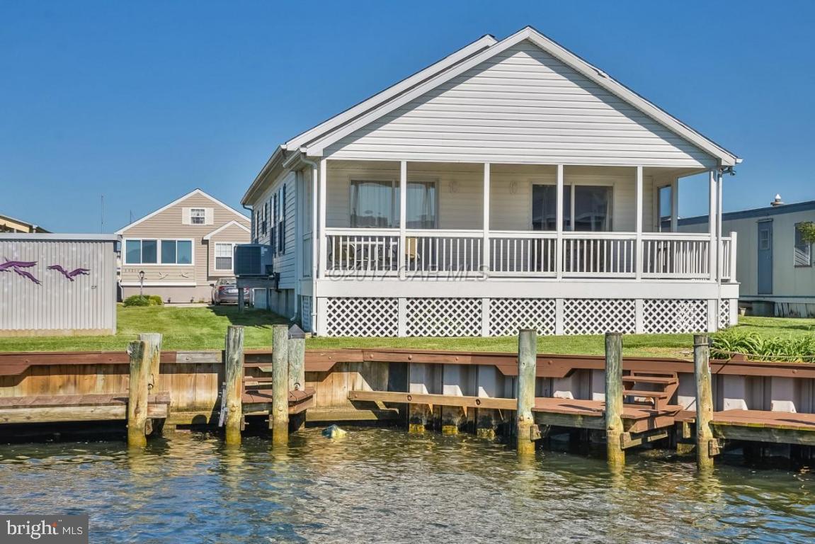 DRASTIC PRICE REDUCTION!!!You won't want to miss this immaculate 3 bedroom, 2 bath waterfront beauty in popular Montego Bay. Bright & airy open concept living with fresh neutral paint & carpet, kitchen with granite counter tops, breakfast bar & stainless appliances, hall bath with granite, 3 ample bedrooms including master with en suite. Enjoy sunsets & crab feasts from the large screened porch overlooking your private dock & impeccably maintained yard, or boat to the open bay. Newer HVAC & full,lighted attic with plenty of storage & extra insulation to keep those utilities to a minimum. Sold completely furnished with super low HOA fees, tons of amenities & just minutes to the beach, shopping & restaurants of North Ocean City.