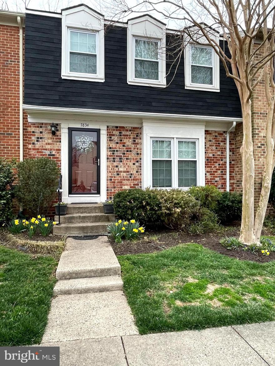 Welcoming foyer invites you into this spacious, renovated, brick colonial townhome! Hardwood floors and luxury vinyl flooring throughout main level. Gorgeous renovated eat-in kitchen with large windows, hardwoods, stainless appliances, 42 inch cabinets, recessed lighting, tile back splash, and pantry. Separate formal dining room and living room provide ample entertaining and living space. Upper level hosts spacious primary bedroom suite with walk-in closet, window seats, additional reach-in closets, all with Elfa organizing systems. Beautifully renovated primary bathroom with handsome granite-top vanity, wide plank tile surround, and frameless glass shower doors.  Two additional generous sized bedrooms also offer carpeting and closets with Elfa organizing systems. Renovated hall bath also has granite countertops and on-trend lighting. Lower walk-out level, updated in 2021, features expansive family room with brick wood-burning fireplace with mantel, access to laundry room, and doors to enclosed patio.  You will love the private enclosed patio with pavers, beautiful plantings, and gate to common area -- ideal for relaxation or entertaining.  Roof new in 2023. Two assigned parking spaces directly in front of the home and ample street parking. Lafayette Village HOA features a swimming pool, trails, a playground, and more. Community backs to Hidden Oaks Nature Center with miles of trails, and so much nature to enjoy! Please, no cats.