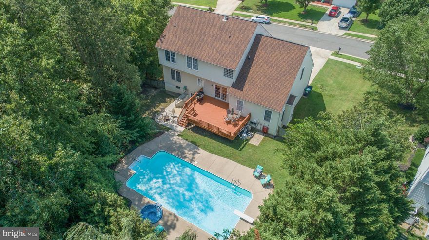 Spending more time at HOME - why not spend it HERE?  This ROYAL OAKS COLONIAL boasts over 4,000 finished sq ft on 3 levels, and a BACKYARD OASIS complete with an IN-GROUND SALT WATER POOL, SPA, PATIO & DECK!  The MAIN LEVEL features a LIVING ROOM/DINING ROOM combination to the right as you enter the TWO-STORY FOYER.  To the left , FRENCH DOORS  showcase an ever-essential HOME OFFICE/STUDY.  An OPEN-CONCEPT main living area awaits with an ISLAND- appointed KITCHEN , BREAKFAST ROOM with an exit onto the rear DECK & a FAMILY ROOM featuring a cozy GAS FIREPLACE.  Beautiful WOOD and LIFEPROOF VINYL FLOORING accent the MAIN LEVEL.   UPSTAIRS, the SPACIOUS MASTER SUITE boasts a VAULTED CEILING,  expansive SITTING AREA & WALK-IN CLOSET plus a SPA-LIKE EN SUITE BATH complete with JACUZZI TUB, SEPARATE SHOWER & DUAL SINKS WITH CABINETRY.    3 ADDITIONAL  BEDROOMS (all with fans & lights) &  a HALL BATHROOM complete the upper level.   On the LOWER LEVEL, an EXPANSIVE RECREATION AREA provides the perfect retreat after playing in the POOL!  A 5TH BEDROOM (not to code) and ADDITIONAL FLEX SPACE that would make a PERFECT MOVIE ROOM,  gives everyone plenty of options to spread out.  Completing the lower level is the home's 3rd FULL BATHROOM.  Your stay-cation dream awaits outside within the FULLY FENCED, private rear yard!  Enjoy a cool dip in the SALT WATER POOL, followed by RELAXATION in the SPA.  Serve dinner on the  DECK, complete with BUILT-IN SEATING, then finish  the evening  with a beverage by the FIRE PIT.   ROYAL OAKS is a CURB & SIDEWALK COMMUNITY with CONVENIENT ACCESS to schools, Harrison Crossing Shopping/Restaurants, commuter lot & I-95.   RIVERBEND HIGH  SCHOOL district.