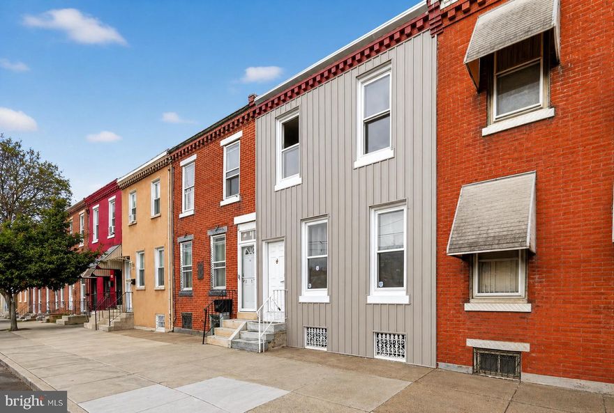 Welcome to this beautifully renovated Philadelphia row home, only a fifteen minute walk to Fishtown, where modern design, quality craftsmanship, and everyday comfort come together seamlessly. From the moment you arrive, the refreshed exterior creates strong curb appeal and sets the stage for the impressive upgrades found throughout the home. Inside, you'll immediately appreciate the bright, open-concept layout filled with natural light, complemented by sleek vinyl flooring and recessed lighting that enhance the spacious main living area.

The stunning kitchen serves as the centerpiece of the home, thoughtfully designed for both entertaining and daily living. Featuring stylish tile flooring, a striking backsplash, a large center island, and brand-new stainless steel appliances, this space offers both sophistication and functionality. A beautifully updated powder room and convenient main-level laundry area add to the home's practical layout. Step outside from the laundry area to your private fenced backyard complete with a cozy deck — perfect for relaxing or hosting guests during the warmer months.

Upstairs, you'll find three generously sized bedrooms, each offering recessed lighting, custom doors, and tasteful finishes that create a clean, modern feel. The fully renovated hall bathroom showcases contemporary tile flooring, a sleek floating vanity, and a beautifully tiled spa-inspired shower. Additional upgrades include a brand-new central air system, providing year-round comfort and peace of mind.