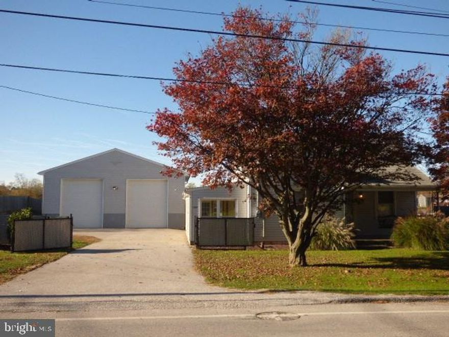 Garage lovers will delight in this exceptionally maintained 1-story home with detached 34x34 garage with high ceilings, two 10x11 overhead doors in rear...big enough to store three trucks, 2 motorcycles and more! The house is move-in condition with everything you need including gas heat, central air, master with full bath and a sun-drenched 4-season room. Walk-up attic, shed, hot tub, nice fenced yard with entry gate, invisible dog fence.