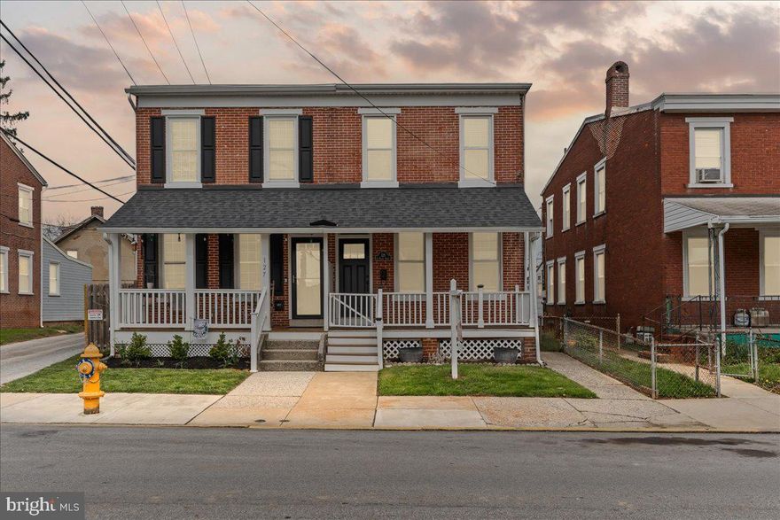 Welcome to 129 E Nields Street, located in the highly sought-after West Chester Borough. Just a short walk to shops, restaurants, and parks, this move-in ready home offers the perfect blend of charm, updates, and an unbeatable location. As you arrive, you're greeted by a welcoming covered front porch—an ideal place to relax and unwind at the end of the day. Step through the vestibule entrance into a classic center hall layout featuring a bright and cheerful living room, a formal dining room, and a spacious eat-in kitchen. The kitchen is a standout with recessed lighting, an exposed brick accent wall, ample cabinetry, and stainless steel appliances including a gas range, dishwasher, microwave, and refrigerator. Just off the kitchen is a convenient laundry/mudroom that leads to the rear and offers a private two-car off-street parking area—a rare find in the Borough. The main level also features tall ceilings and beautiful hardwood flooring throughout.

Upstairs, the second floor offers three generously sized bedrooms and a beautifully renovated hall bathroom with new tile flooring, a new tub with tiled surround, a modern vanity, and new fixtures. Additional highlights include a high-efficiency Carrier Infinity HVAC system, a newer high-efficiency hot water heater, updated 200 AMP electrical service, new water service line, and new ceiling fans in all bedrooms. This well-maintained home is a true gem in one of the most desirable areas of West Chester. Don’t miss the opportunity to make it yours!