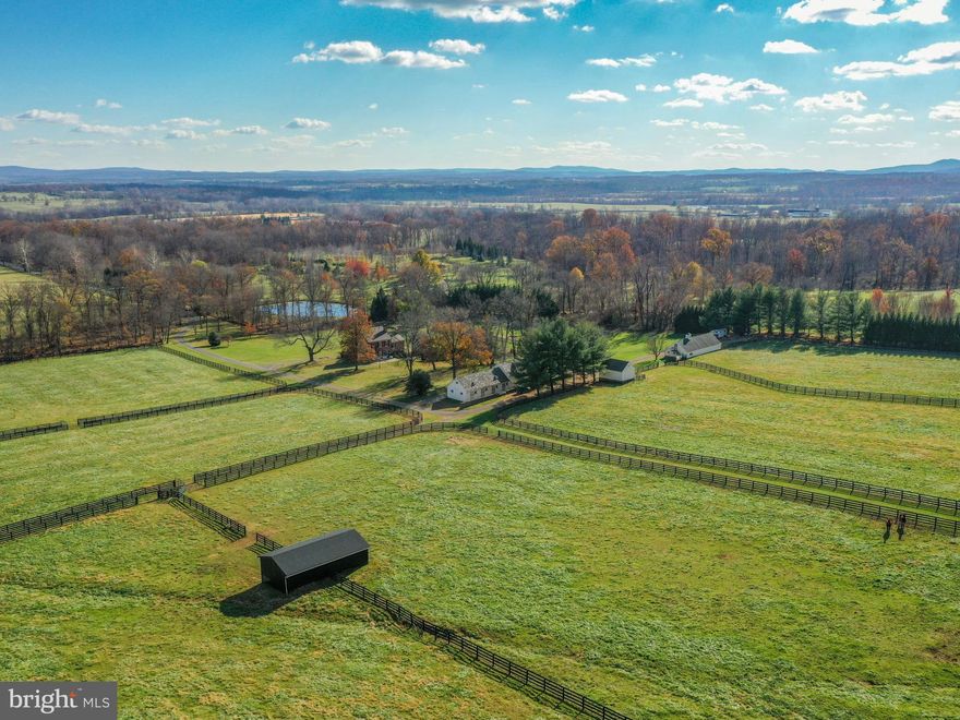 Day Spring Farm is a very private, secluded yet serene, 100 acres in the hills & foothills of the Blue Ridge Mountains.   You can feel the abundance of character and charm as you ride or drive down the long driveway.  Surrounded by hundreds of protected acres, yet not in easement, this property has the perfect balance of open and wooded land.  Located in the heart of horse country and in the Piedmont Fox Hunt territory, there is lots of ride-out too.  The incredible views cannot be missed while walking out to catch your horses in the back pastures, and the sound of the birds and wildlife is truly captivating.  Approximately 65 acres remain wooded allowing for exceptional timber cutting, hunting, hiking, camping, riding, 4-wheeling, and all of your outdoor adventures.  This charming federal style-all brick farmhouse is surrounded by about 35 acres of open, lush & green pastures with 4-board fencing, automatic waterers & oversized run-in sheds.  A 12-stall horse stable sits a good distance from the house, along with a luxurious chicken coop, a massive workshop, a sawdust building, a large riding ring, a pond and spring house, and so much more!  Just outside of the home is an in-ground pool with a proper 2-story stone pool house/office/guest house.  The pool house used to be an old smoke house many years ago and has been thoughtfully converted into an office which has its own kitchenette, & bathroom with heat/A/C.  In addition to the separate pool house/office/guest house, the barn conveniently has its own 1-bedroom income producing apartment.  The main home features a grand and spacious entryway with wide stairs leading all the way up to the 3rd floor.  Large windows throughout, provide lots of natural light and farm views in every direction.  There are 5" Heart Pine hardwood floors on the first and second floor and a fireplace in every room!  The Kitchen was recently remodeled, has a wood stove, updated appliances, and all the essentials.  The whole home has been upgraded to geothermal heating and air conditioning and is all ready for its new owners to enjoy.  Seller needs a 2 month rent-back & please contact listing agent for items that do not convey.  Please call to schedule an appointment today, you won't be disappointed!