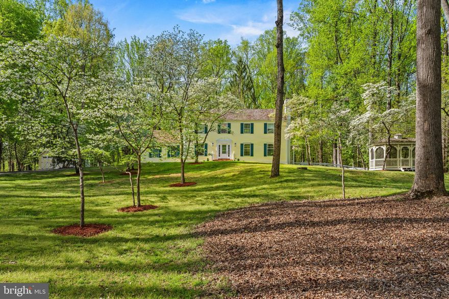 Nestled on 2.38 private, wooded acres in sought-after Great Falls, this beautifully updated 3,645 sq. ft. Colonial home features 5-bedrooms and 3.5 baths and offers the perfect blend of space, comfort, and natural serenity. Ideally located at the end of a quiet cul-de-sac, the home is just minutes from Great Falls Village, Tysons Corner, and within walking distance to the Potomac River. 
The thoughtfully designed layout features four spacious upper-level bedrooms with oversized closets, plus an additional bedroom on the walk-out lower level, ideal for guests or an au pair suite. The expansive finished basement boasts hardwood floors and flexible living space for recreation, work, or fitness. Two wood-burning fireplaces in the home add warmth and charm.
Recent updates provide peace of mind, including a new roof (2026), water filtration system (2025), new HVAC systems (2024), and dual washer/dryer sets on both upper and lower levels for added convenience. The home has been extensively updated in recent years, offering true move-in readiness.
Outdoor living shines with a large deck overlooking an expansive, wooded backyard that is fully fenced, perfect for entertaining or relaxing in total privacy. The property also includes a heated 3-car garage with insulated garage doors, a custom Amish-built shed, screened-in gazebo and storage shed. 
Tucked within Great Falls’ highly desirable River Corridor, this property offers immediate access to the area’s most treasured outdoor amenities. Enjoy a short walk to scenic bridle paths and the expansive natural beauty of River Bend Park.
Located within the Langley High School district, 9201 Potomac Woods Lane presents a compelling opportunity for a private, multi-acre estate in one of Great Falls’ most prestigious settings.