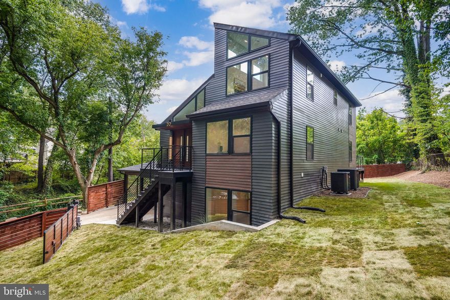 Welcome to your suburban oasis, nestled just steps away from the serene Sligo Creek Park in the heart of Takoma Park, Maryland. This modern, 5-bedroom, 3.5-bathroom contemporary masterpiece offers a harmonious blend of tranquility, convenience, and sleek design, all mere minutes from the vibrant energy of Washington, DC.

Boasting a captivating exterior adorned with two-toned Hardi siding and an artful arrangement of black-framed windows, this home exudes an abundance of natural light and contemporary charm. As you step inside, the grandeur of soaring ceilings and the inviting allure of white oak wood floors extending throughout the main and upper levels welcome you with open arms.

The heart of this residence lies within its expertly designed kitchen, adorned with elegant European two-tone cabinets, a generously sized waterfall island, and resplendent Royal Grigio quartz countertops and backsplash. High-end stainless steel appliances stand ready to elevate your culinary endeavors. A sun-drenched dining area and family room, adorned with expansive windows, create a seamless indoor-outdoor connection, while a striking two-sided electric fireplace serves as a centerpiece of warmth and sophistication.

The main level is graced by a luxurious primary bedroom, featuring a walk-through closet that leads you to an ensuite bathroom of refined decadence. Here, a floating dual vanity and a spacious glass-enclosed shower await, showcasing captivating floor and wall tiles that epitomize modern opulence.

Venture to the upper level, where two generously sized bedrooms bask in natural light beneath the lofty embrace of vaulted ceilings. Expansive windows bridge the gap between indoor comfort and the allure of the outdoors. The upper-level bathroom boasts dual vanities, a capacious tub/shower combo, and a herringbone tile surround, adding an element of tasteful sophistication.

Descending to the walkout lower level, discover two additional full bedrooms, an artfully crafted bathroom exuding luxury, and a generously proportioned recreation room complete with a wet bar—a haven for relaxation and entertainment. Outside, your fully fenced backyard beckons with ample space, complemented by a substantial composite deck awaiting your personal touch.

Additional amenities include a substantial driveway, a covered carport, and a secure gated entry that guarantees both convenience and privacy. Immerse yourself in the perfect synergy of modern living, lavish comfort, and the serenity of suburban life, all within arm's reach of the bustling heart of the nation's capital. This listing is an embodiment of architectural brilliance and contemporary elegance, promising an extraordinary lifestyle for the discerning homeowner.