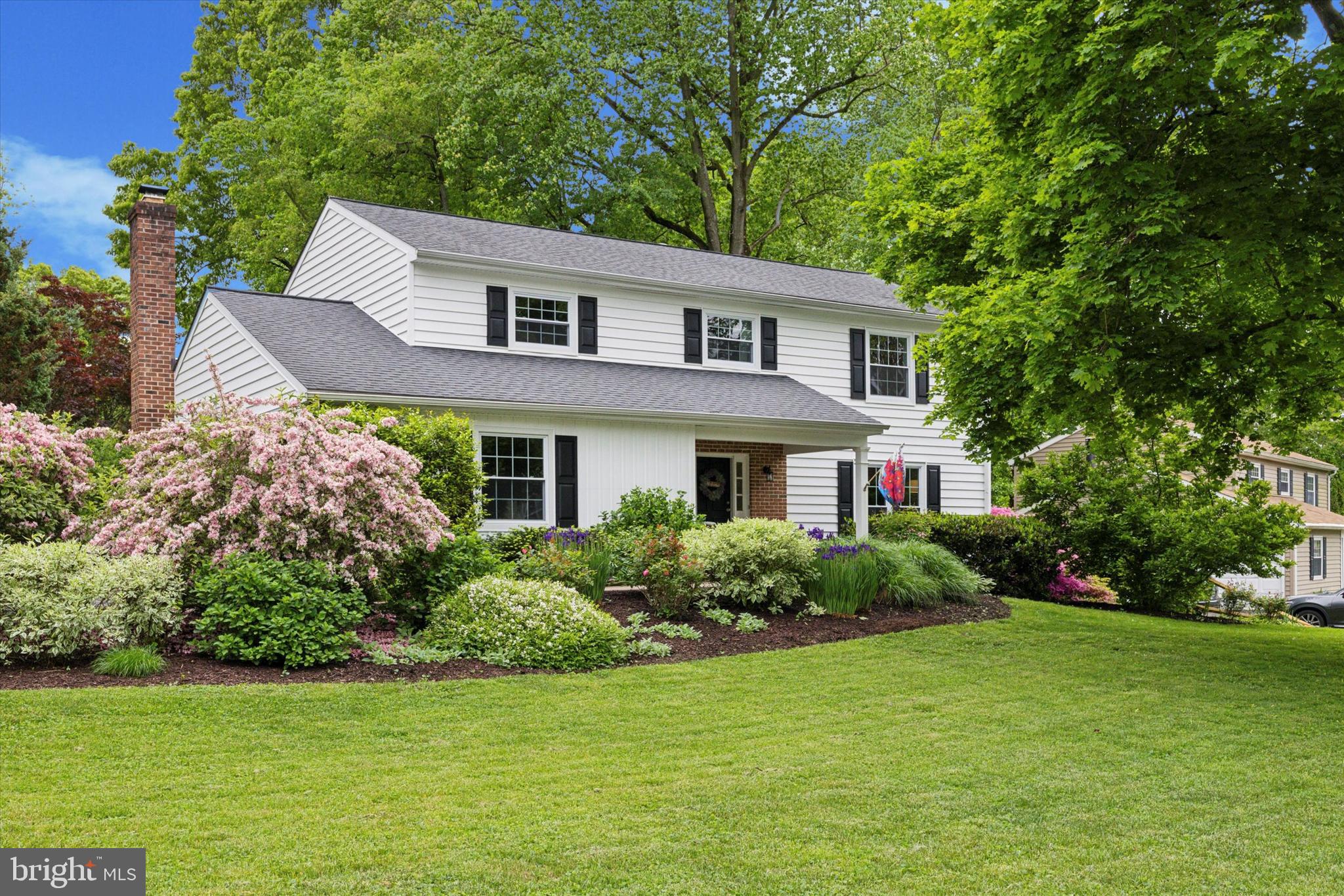 Situated on walkable and quiet Ridge Road, this five-bedroom home is surrounded by beautiful and lush landscaping. The lot is just more than a half-acre and the home is perfectly positioned for privacy, especially when in the wonderful large and flat back yard! The roof is newer with a transferrable warranty and there is a generator hookup. The eat-in Kitchen is the heart of this home and features a new dishwasher, quartz counters, tiled backsplash, double sink, wood-look vinyl flooring and recessed lighting. With views to the back yard and deck access, the Kitchen is also open to the Family Room. The Family Room is newly carpeted and features a wood-burning fireplace with woodstove insert and a full brick surround, mantle and seating! A sliding glass door opens to the screened porch with skylights. Formal Living and Dining spaces feature hardwood flooring and a Powder Room competes the first level. Upstairs are five newly carpeted bedrooms, Hall Bath with tub and shower and the Primary Bedroom is ensuite with a tub, shower and towel warmer. The wall between the 4th & 5th bedroom was added and could be removed to create one larger bedroom or office. The full basement is unfinished and has hookups for two washers and two dryers if needed. The two car garage has attic storage and there’s a storage shed in the back yard. The owners say they’ve loved the neighborhood, walking the wide streets, appreciating the very private back yard and the way the deck is shaded in late afternoon. Minutes to Malvern Boro and SEPTA Malvern train station. Yes, the taxes really are that low!  Don’t miss this lovely home! (Please note that the tax record is incorrect; the home has public sewer service and five bedrooms.)