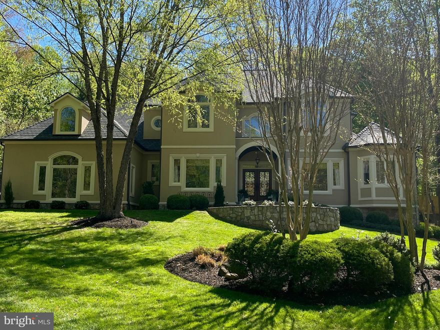 ***2.75% assumable VA loan on a $1.83 million balance, truly the opportunity of a lifetime.*** It is with distinct pleasure that we present 11300 Stonehouse Place, sitting on nearly two beautifully landscaped acres and perfectly positioned in one of Northern Virginia’s most coveted areas. Situated in the charming and picturesque golf cart community of The Estates at Lowes Island and backing to 500+ magnificently beautiful acres that is Seneca Regional Park and the Potomac River with golf cart access to the Trump International Golf Course, this home and neighborhood embodies every detail that is desired of a Great Falls address. Beautiful by day and stunningly majestic by night, this home leaves nothing to be desired and everything to be appreciated. Flooded with natural light, watch the morning sun rise through the grand windows and cast shadows that dance across the walls of the home where, in the evening, the moon will peak through the Seneca trees and rise to shine right into the living room. Marrying form and function with beauty and elegance, this true-to-design Mediterranean styled custom-built home with new roof offers a fully remodeled white kitchen with shaker cabinets, abundant storage, beautiful lighting, marble and quartzite countertops, a wine chiller, and top of the line Kitchen Aid appliances. Step out onto the elegant screened porch with vaulted wood detailed ceilings to sit by the outdoor fireplace or escape with your evening cocktail or out to the elegant deck or travertine tiled patio to enjoy your personal oasis, amazing gardens and relaxing waterfall in the fully private backyard. Surrounded by a beautiful 7 foot custom fence built by Long Fencing Company with two locking gates, you will possess exclusive access to the all of the beauty of Seneca Regional Park and the Potomac. Hop in your Club Car and head down to the golf course to revel in the exclusive 3rd of July fireworks display, enjoy golf cart trick or treating for Halloween or just meander about enjoying the beauty and magnificence of the neighborhood. Enjoy the convenience of an elegant first-floor owners suite with charming views of the private outdoor space, a fully remodeled five-piece spa bathroom with soaking tub and walk-in shower. The homes interior includes over 6500+ square feet of finished living space with a total of five large bedrooms and four bathrooms on the upper two levels. The basement is a wonderful area to entertain as it is open concept with media room area with surround-sound, game room area, and large gym as well as a full bathroom with a steam shower and abundant storage that can easily be transformed into a wine room, theater room, extra bedroom, wet bar, etc. The homes stucco and stone exterior blends beautifully with the treed surroundings while the interior is richly appointed with custom finishes. Beautiful hardwood floors, updated paint color schemes, all new carpet, new light fixtures, door hinges and knobs, and custom blinds throughout the home truly put on the finishing touches. This home is zoned for the highly desirable Langley High School, Cooper Middle School and Great Falls Elementary pyramid and the school buses pick up right at the corner. Residents of the Estates at Lowes Island have access to five neighborhood pools and tennis courts, with one pool conveniently located directly across Stonehouse Place. And, as an added bonus, the neighborhood has underground power lines and is connected to public water and sewer, a rarity in Great Falls.  Schedule your private showing today and be sure to carve out enough time to make the most of your visit by touring the neighborhood and the paved portions of Seneca Park in the residence’s four passenger Club Car.