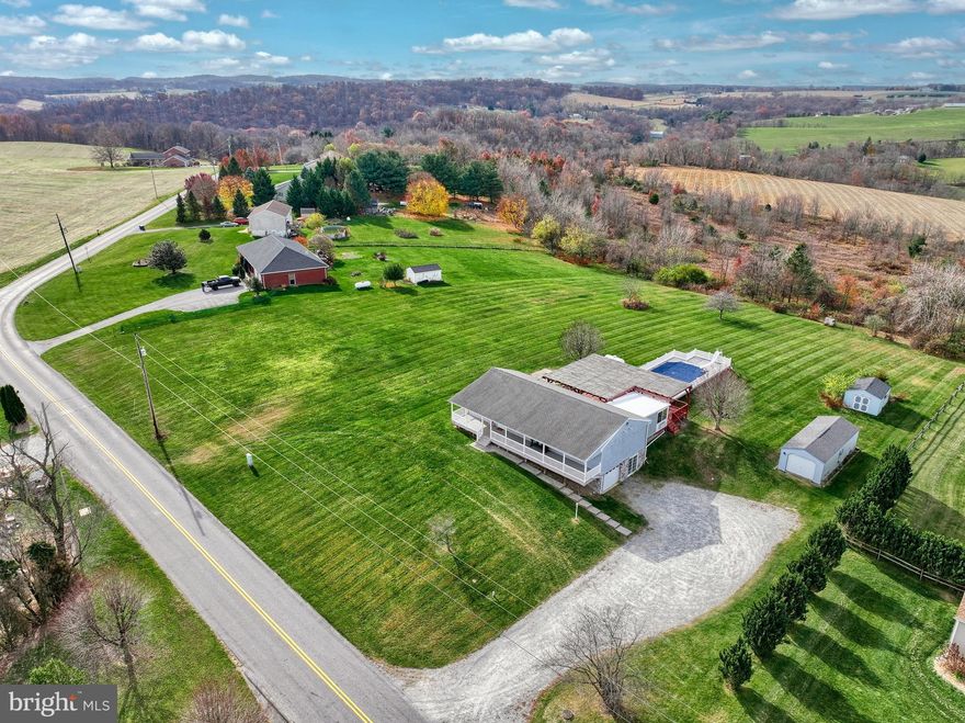 HUGE is the one word that describes this Loved and well cared for HOME. Starting with 58 feet of maintenance free covered front porch that is 8 feet deep. Plenty of space to enjoy this beautiful and rural country setting. Once you enter, prepare to be impressed with the open floor plan and 3 bedroom and 2 full baths all on the main level. Main suite on one side and the other two on the other side of home, perfect floor plan for the growing family. Huge eat in kitchen that connects to a Huge FR that connects to a all-season room with new LVP floors. Walk right out to the deck, or should I say HUGE 48X40 covered deck with HUGE above ground pool. All of this on a 2-acre lot with tons of outside space for the family, such as fire pit, volleyball or just about any outside activities.  The lower-level features large amounts of space that can be used to add additional living space and also includes an additional bedroom and full bath. 1 car garage built in and a walk out. All this on a HUGE 2 ace look with tons of views to enjoy!