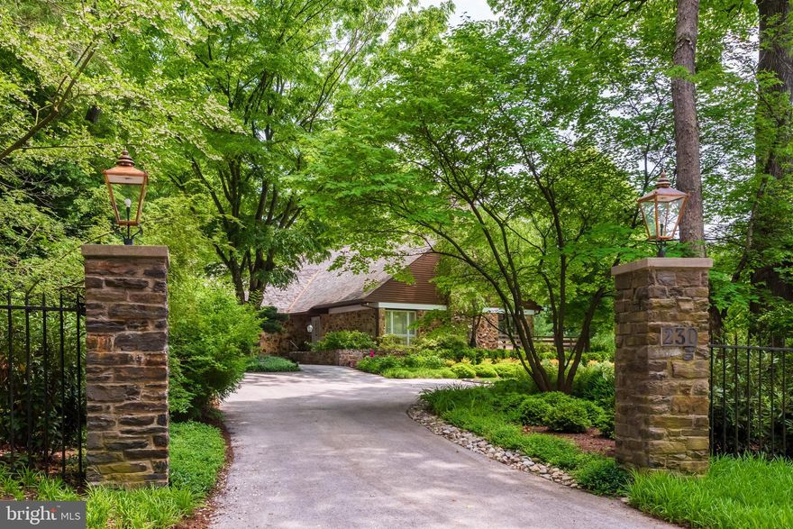 This description paints a vivid picture of an extraordinary residence, where every detail has been carefully crafted to create a luxurious and inviting atmosphere. The original owners clearly spared no expense or imagination in designing this custom-built contemporary home. From the mature perennial gardens to the two-tiered massive deck, every outdoor space is designed for relaxation and entertaining. Inside, the entrance foyer sets the tone for simple elegance, leading to formal living with a fireplace, adjacent formal dining room with custom built-ins, and access to a screened-in flagstone patio.

The home features stunning hardwood flooring, complementing the Pella windows that allow natural light to flood the spaces, particularly benefiting from the southern exposure lot. Soaring ceilings add to the grandeur, creating an open and airy feel in every room. The gourmet kitchen is sure to delight any chef, with a breakfast area, while the family room with its built-in bar area and fireplace provides access to the solarium and rear decks.

The highlight of the home, undoubtedly, is the two-story stone solarium, a tranquil oasis flooded with natural light—a true sanctuary for relaxation and rejuvenation. The first-floor master suite offers a retreat-like experience, complete with a substantial, modern master bathroom and convenient access to the solarium. Additional bedrooms on the second level provide ample space for family or guests, with two additional full bathrooms and plenty of closet space. There is a balcony room overlooking the living room that further enhances the appeal.  There is an unfinished basement with an outside exit offering plenty of storage, a two-car oversized attached garage, and a driveway with stone pillars, providing both practicality and luxury in abundance.

Exposed stone and pine ceilings adorn many of the main rooms, while the cedar and stone exterior adds to the home's distinguished appearance. Custom lighting enhances both the interior and exterior of this magnificent property, situated on 1.480 acres of meticulously maintained grounds and landscaping. The flagstone patio and walkway entrance welcome you to this stately property, ensuring that you will not be disappointed. It's no surprise that a property of this caliber would be highly coveted within Merion Station.