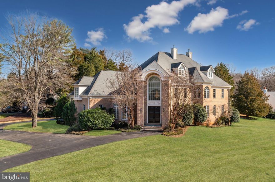 Prominently positioned on a private one-acre parcel in McLean, 6511 W Langley Ln is a breathtaking, custom-built estate of palatial scale and luxury detail. Meticulously designed and thoughtfully curated, the home’s open floor plan is precisely planned out with generous proportions, phenomenal finishes, and a lengthy list of amenities. The expansive 13,500 SF property offers 7 BR, 7 BA, 2 HB, an Elevator, Wine Cellar and 3-car Garage + driveway parking. All 4 finished levels of this McLean estate have been flawlessly designed to offer a seamless blend of functionality and large-scale living. This includes vast entertaining spaces, numerous guest quarters, ample outdoor living spaces and expansive storage areas. Lush, south-facing lawns and gardens surround the rear of the sprawling estate, providing ultimate privacy. 
The grand Foyer is a stunning welcome to this unforgettable home, catching your eye with its soaring 18’ ceilings, 3-story window, gleaming marble floors and grand staircase. The notable entry opens to the formal Dining and Living Rooms separated by columned archways and complete with a gas fireplace and balcony. The Gourmet Kitchen is outfitted to suit nearly every caliber chef with luxury stainless steel appliances, large island, walk-in pantry and custom cabinetry. Appliances include Sub-Zero refrigerator, 2 Wolf Ranges, 2 Wolf Wall Ovens, Wine Fridge, 3 sinks, and 2 dishwashers. The oversized Family Room is conveniently located adjacent to the Chef’s Kitchen and offers direct access to the Main Level’s Patio, Screened Porch, and Terrace for idyllic al fresco dining and entertaining. 
Accessible by the elevator or grand staircase, the residence’s Second Level features 5 en-suite Bedrooms, including the enviable Primary Suite. The extensive Primary Suite boasts a Sitting Room, Dressing Room, Wet Bar, 3 Walk-In Closets, Gas Fireplace, Private Balcony and Spa Bath complete with marble flooring, a large soaking tub, dual vanities, 2 towel warmers and a marble shower. 
The Third Level has vaulted ceilings throughout and features an additional Guest Suite with Wet Bar, Bonus Room with Skylight and Office space. The sprawling Lower-Level showcases something for everyone with a Recreation Room, Office, Exercise Room, Laundry Room, Stone Wine Cellar, Second Kitchen and ample storage space. A large, covered terrace is accessible from the Lower Level and also features a gas fireplace.