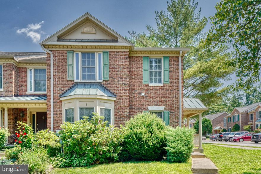 Picturesque setting in Greenspring East.  Brick front end of group townhome exuding curb appeal.  Side entry to open foyer welcomes you home with hardwood flooring and architectural arches for something a little special.  Expansive living room with hardwoods, crown molding, recessed lighting, and focal point double-sided fireplace.  Formal living space with wainscoting, crown molding, crystal chandelier and access to the deck.  This is the perfect spot for entertaining with flow to the both the deck and kitchen.  Ample kitchen with tile flooring, abundant cabinetry, granite counters, and beautiful 3-piece window for bird watching while sipping the morning coffee/tea.  Upstairs is the primary sanctuary with large windows, vaulted ceiling, & walk-in closet.  Retreat to the spa like primary bathroom with soaking tub, dual vanities, and separate shower with state-of-the-art body sprayer & shower head.  The 2nd level also features 2 additional bedrooms and hall bathroom.  The finished basement features a bedroom, full bathroom, and family room perfect for watching movies and relaxing.  Outdoor living is a breeze with the expansive deck with built-in storage overlooking the tree lined common area. Convenient location to the Quarry shops, restaurants, beltway and schools.  Come enjoy the easy life at 1 Willwood Court.