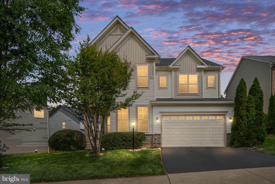Nestled in the prestigious Liberty Manor subdivision, this exquisite Colonial-style residence offers a harmonious blend of luxury and comfort, perfect for those seeking an elevated lifestyle. Built in 2013, this home boasts a generous 4,342 square feet of meticulously designed living space, featuring 4 spacious bedrooms and 4 full and 1 half elegantly appointed bathrooms. Step inside to discover a warm and inviting interior adorned with crown moldings and chair railings that enhance the home's sophisticated charm. The gourmet kitchen is a culinary enthusiast's dream, equipped with stainless steel appliances, including a built-in microwave, wall oven, and a sleek cooktop with downdraft ventilation. The expansive kitchen island provides ample space for meal preparation and casual dining, while the adjoining breakfast area invites leisurely mornings filled with sunlight. The family room, seamlessly connected to the kitchen, features a cozy Heatilator fireplace, perfect for gathering with loved ones on chilly evenings. Large insulated windows throughout the home allow natural light to flood the space, creating an airy and welcoming atmosphere. The primary suite is a true retreat, complete with a luxurious soaking tub, oversized walk-in Shower, dual split location sink/prep areas with upgraded countertops, ensuring a spa-like experience at home. The partially finished basement offers additional living space with walkout stairs, providing endless possibilities for customization. With a full bathroom and space for extra rooms, it's ideal for entertaining or creating a private sanctuary. Outside, the property is beautifully landscaped, featuring a level lot that backs onto an open common area, providing a serene backdrop for outdoor activities. Enjoy evenings on the back deck or patio, or relax on the charming front porch or upper oversized balcony while taking in views of the lush garden and lawn. The attached two-car garage, complete with a garage door opener and inside access, adds convenience to your daily routine. Liberty Manor offers a vibrant community atmosphere.  With commuter lots less than five miles away, this home provides easy access to urban conveniences (schools, shopping, parks, Medical Facilities, I95, PW Parkway) while maintaining a peaceful suburban lifestyle. Experience the perfect blend of elegance and comfort in this exceptional property, where every detail has been thoughtfully curated to create a true sense of home.