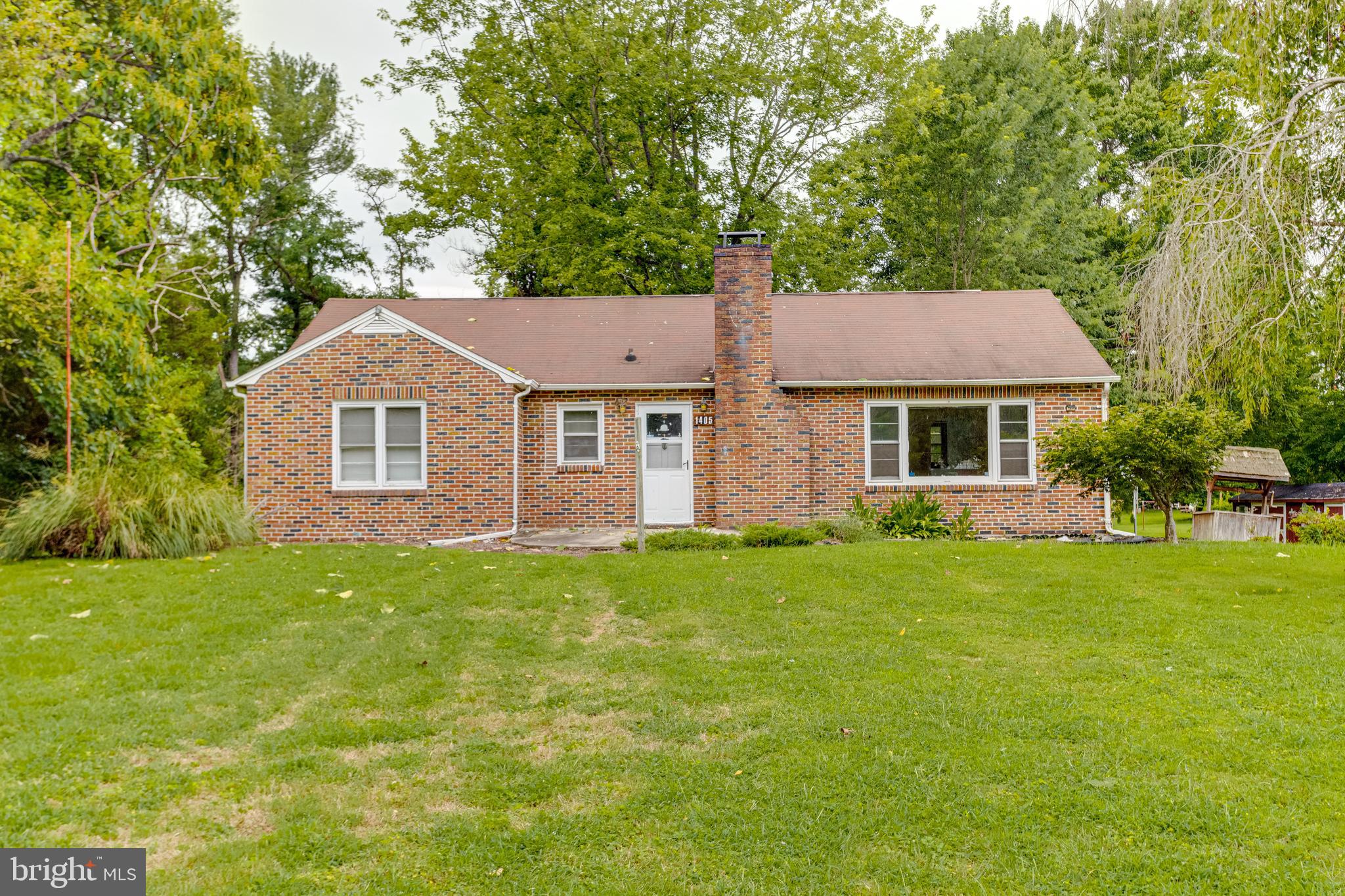 As an added bonus, this sale includes a separate 1.25-acre buildable lot tax number A-01-065793 , giving you rare flexibility for expansion, investment, or simply added privacy. Whether you’re a buyer looking for a place to make your own or someone who sees the potential in a home with extra land, this Abingdon property offers an incredible opportunity that doesn’t come along often.
Welcome to 1405 Pomeroy Ave in Abingdon, MD! This solid all-brick rancher sits on .48 acre lot and offers 3 bedrooms and 1 bath and sits in a prime location just minutes from I-95, shops, restaurants, and all the conveniences you could need. From the moment you step inside, you’ll notice the charm and character of the home, featuring beautiful original hardwood floors throughout and a classic brick fireplace that serves as a warm focal point in the living area. The home has been well maintained and provides a strong foundation for your vision, offering the perfect opportunity to bring in modern updates while preserving its timeless appeal.
The main level offers comfortable living space, while the full walkout basement is partially finished and ready to be customized to your needs. Whether you want to create additional living space, a home gym, or the ultimate man cave, the possibilities are endless. Outside, the property shines with its .48-acre lot, offering room to relax and enjoy the outdoors. The backyard is a true nature lover’s retreat, with tons of wildlife to watch, from songbirds to deer grazing just beyond the trees.