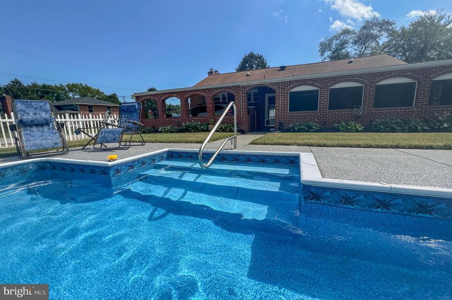 This exceptional corner-lot property delivers the perfect blend of space, function, and lifestyle—featuring dual driveways, a carport, and an incredible 4-car garage with upper-level storage, ideal for car enthusiasts, hobbyists, or the ultimate workshop setup.

Step inside this classic red-brick rancher and immediately feel at home in the warm, inviting living room, highlighted by a sun-filled bay window and a cozy pellet stove—perfect for relaxing evenings. The light-filled dining room flows seamlessly into the kitchen, creating an open and functional layout designed for both everyday living and effortless entertaining.

The spacious kitchen is a true standout, offering abundant cabinetry and counter space, granite countertops, a Jenn-Air range, recessed wall oven and microwave, and even a dedicated space for your coffee station. A pantry is conveniently tucked just behind, while the entry room doubles as a practical laundry area.

The home features two generously sized bedrooms and two full baths, including a private en suite in the primary bedroom for added comfort and privacy.

Downstairs, the expansive lower level unlocks endless possibilities—create your dream home theater, gym, recreation room, or gathering space. Additional storage is easily accessible via pull-down attic stairs.

Step outside and experience the true highlight of this property—your own private backyard retreat. The fully fenced yard showcases a sparkling 18’ x 36’ in-ground pool, surrounded by an upgraded patio with a lifetime transferable coating, plus a gazebo that sets the stage for unforgettable summer entertaining. A large double-door shed with electric and lighting adds even more versatility.

The oversized 4-car garage is a rare find, complete with its own bathroom, separate electric panel, and ample room for vehicles, projects, or a full workshop—truly a dream space.

Major updates provide peace of mind, including:
Roof (2018), Pool liner with Pentair Quad DE filter & pump (2018), Water heater (2018), Fuel oil tank (2019), Backyard concrete (2023), and premium polyurea/polyaspartic coating (2024).

Situated on a combined .43-acre double parcel (18,750 sq ft), this property offers space, flexibility, and value rarely found.

This is more than a home—it’s a lifestyle. Don’t miss this one-of-a-kind opportunity.