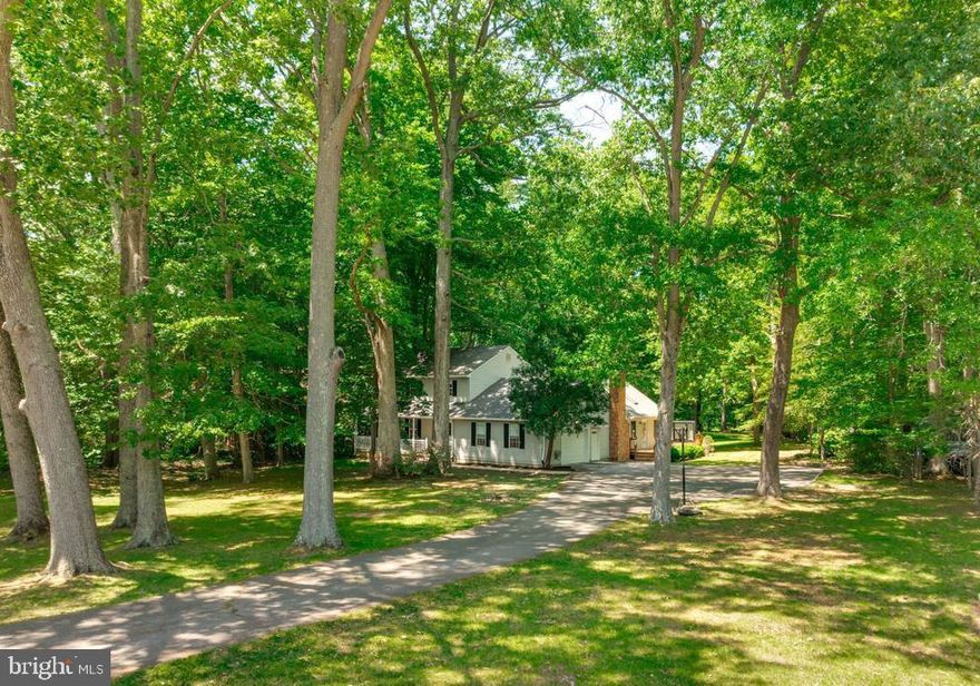 Tucked away on a private, wooded one- acre lot, this waterfront home offer the perfect blend of tranquility and comfort. Featuring  four bedrooms and  2 1/2 bathrooms, the property is located on a small Patuxent River cove, includes a floating dock/pier and access to a community boat ramp onto the Patuxent River - ideal for boating, kayaking and waterfront living. Inside , the spacious great room overlooks the backyard and peaceful riverfront setting, while a wood burning, brick fireplace creates a warm and inviting centerpiece. The kitchen is equipped with a solid surface countertop and stainless appliances, combining style and functionality for everyday living and entertaining. Enjoy outdoor living from the large backyard deck or relax on the front porch surrounded by mature trees and natural beauty. A winding path through the tree lined yard leads down to the waterfront cove, offering  a private retreat just steps from your door.