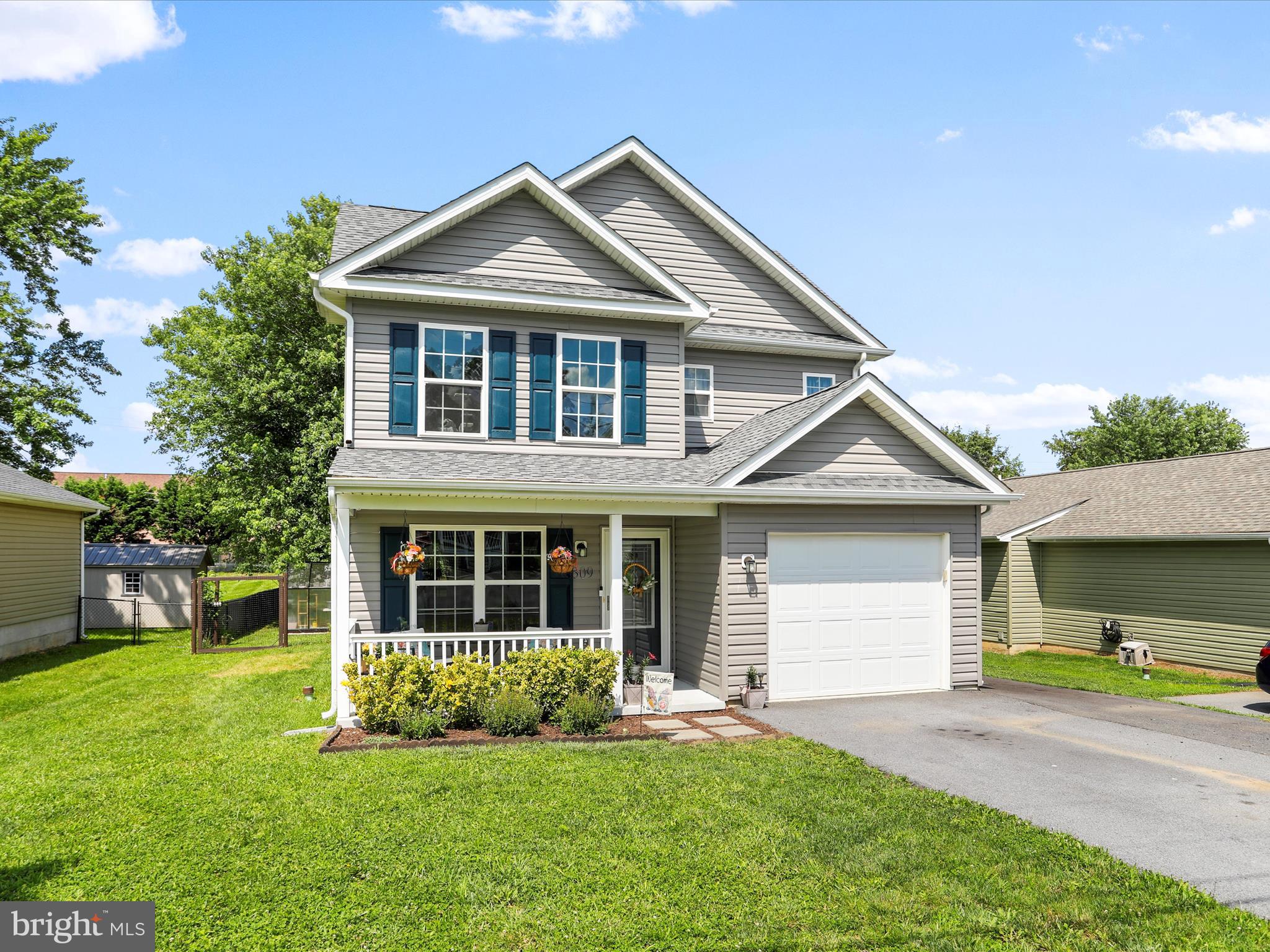 Welcome to this meticulously maintained Colonial-style home, perfectly located in the heart of Martinsburg. Only 5 years old, this 3-bedroom, 2.5-bathroom charmer offers 1,270 sq ft of thoughtfully designed living space with modern features and classic charm. There are many cool nuances within this living space including soft LED lighting in the kitchen, The main-level primary suite includes an en-suite bathroom for added privacy and convenience, while two additional bedrooms and a full bath are located upstairs. The open-concept living and dining areas create a warm, inviting atmosphere, ideal for both everyday living and entertaining. The kitchen is outfitted with stainless steel appliances, including a refrigerator, range/oven, microwave, and dishwasher. Enjoy durable laminate flooring throughout the main living spaces, a heat pump system for year-round comfort, and an attached one-car garage with extra storage space. Step outside to a fully fenced backyard featuring a cozy covered back porch and functional greenhouse for those with a green thumb. Great time and effort were placed into creating a peaceful sanctuary, complete with firepit area. The large, flat lot (.23 ac) could easily accommodate a substantial storage shed, or trampoline, or corn hole area if you desire. This location offers convenience as it is near local schools, parks, shopping, MARC train and major commuter routes. This home offers the best of comfort, space, and accessibility.