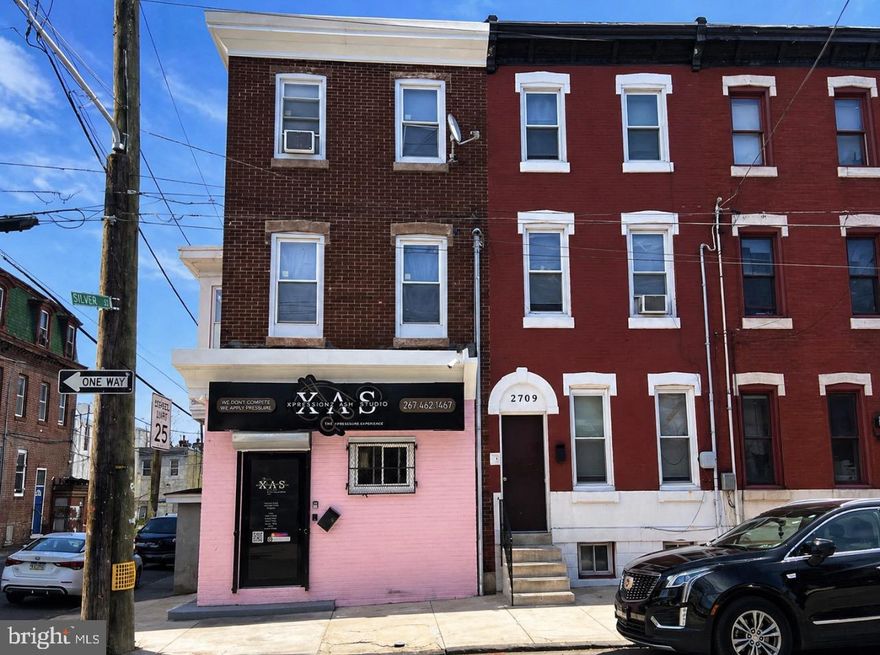 2711 N. 11th St presents an exceptional mixed-use investment opportunity with commercial zoning and strong income-producing potential. This recently renovated property features a ground-floor commercial space currently operating as a salon, offering immediate business or rental use in a high-visibility location. Above the commercial unit, the second floor includes a beautifully updated 2-bedroom, 1-bath apartment, while the third floor offers a spacious renovated 3-bedroom residential unit. All units have been thoughtfully upgraded, creating a turnkey opportunity for investors or owner-occupants alike. The property also includes a private yard, adding valuable outdoor space, while the unfinished basement with its own private side entrance provides additional storage or future expansion possibilities. Whether you’re looking to expand your portfolio, operate your business below, or maximize rental income, this versatile mixed-use property offers endless potential.