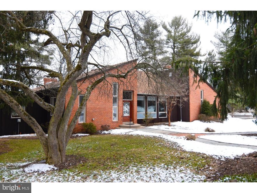 EXTRAORDINARY CONTEMPORARY!  If you are looking for something that is not cookie cutter and you want to have some privacy, yet be convenient, this may be the one!  This freshly painted 4-5 Bedroom contemporary home has so much to offer!  Lots of windows, makes this home naturally bright!  Step inside through the beautiful front door with leaded glass into the tiled and brick vestibule, before entering into the home with open floor plan.  You will immediately be impressed by the gorgeous wood flooring which leads into the living room and kitchen/dining areas with vaulted ceilings.  The 49 handle kitchen offers handmade wood cabinetry, a large island/breakfast bar with cooktop, marble countertops, subzero refrigerator, double bowl sinks, double wall oven and dishwasher overlooking the front and rear yards.  The huge master bedroom has brand new carpet, it's very own wood burning fireplace, vaulted ceilings, skylight, French doors leading to private deck, a humungous walk in closet and sunken master bath with double bowl sinks, bidet, large tiled shower, tile floors, and corian countertops.  On the other side of the home, you have a first floor laundry, another full bath, and 3 more nice size bedrooms with lots of windows.  You also can access the oversized garage with walk up loft from this side of the home, as well as the basement, which leads into a large workshop area overlooking the rear patio.  This space could easily be finished off into more living space if needed.  Spiral staircase in the dining area leads down into the finished basement with bar, which has refrigerator and is equipped for a sink.  The amazing brick fireplace and lots of French doors leading to a patio, make this area great for entertaining year round.  The 5th bedroom or office is located on this level as well.  The HVAC system has recently been serviced and in working order with the exception of the basement.  Come take a look at this one of a kind property, ready for quick possession.