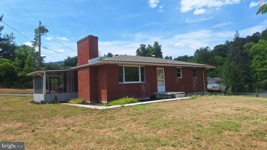 Situated on a spacious .7-acre cleared and level lot with mountain views, this charming and solid all-brick  home offers the perfect blend of tranquility and convenience.  The large kitchen features oak cabinets, a new refrigerator, breakfast bar, bright skylight, and recessed lighting with ample cabinet and countertop space. The kitchen walks out to the screened porch overlooking the yard.  The living room, with its picture window and wood-burning stove, creates a cozy atmosphere and there is newer carpet throughout the living room and bedrooms.  This home originally had 3-bedrooms and can easily be converted back, with closets and ceiling fans on each side of the current second bedroom .  All bedrooms have plenty of closet space and the lower walkout level offers the potential to easily be finished into a recreational room or additional living space, adding even more versatility to this lovely home.
