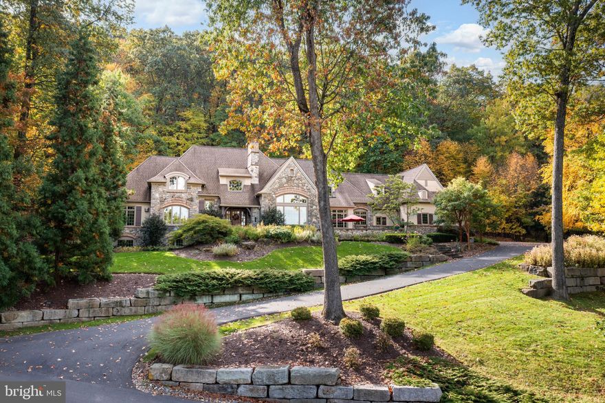 This exceptional CUSTOM-BUILT ESTATE HOME is located in the prestigious WEYHILL WOODS of Center Valley. The meticulously landscaped grounds and INCREDIBLE VIEWS of the Valley make this property truly remarkable. As you enter the two-story grand foyer, you are greeted by a formal dining room. A private hall leads to the FIRST-FLOOR PRIMARY SUITE and office, providing a luxurious oasis for relaxation. The WELL-DESIGNED FLOOR PLAN features 9-foot ceilings and 8-foot doors throughout the first floor. The two-story great room, with its floor-to-ceiling stone fireplace, offers breathtaking views through large windows. The GOURMET KITCHEN, equipped with top-of-the-line appliances, a wet bar, and a butler's pantry, opens to a cozy breakfast room with a gas burning fireplace. On the second level, you will find three comfortable and spacious en suite bedrooms, a cozy sitting room, and an additional office/craft room. The lower level boasts a FINISHED RECREATION ROOM with half bath, and ample storage space. The MAGNIFICENT enclosed front stonewall patio offers sweeping views, and the ENCHANTING BACKYARD is a private sanctuary, both just perfect for entertaining and creating lasting memories. Conveniently located near shopping, academic institutions, SVCC, and easily accessible to NJ/NYC/Philadelphia.