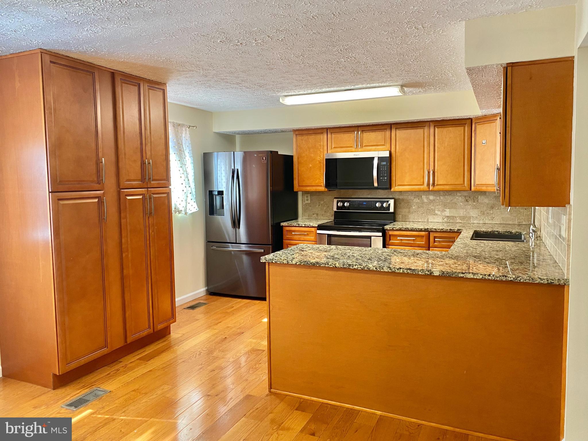 Enjoy the extra yard space this well-cared-for end unit, brick front townhome offers, ideally situated in Howard County and close to I-95. Spend quiet moments in front of the fireplace in the finished lower-level family room or outside on the deck overlooking the fenced backyard. Features a large country kitchen, new carpet, and recent updates to roof, windows, water heater, HVAC, and baths (all less than 5 years old). Features 3 bedrooms and 3.5 bedrooms. The community has a neighborhood tot lot.