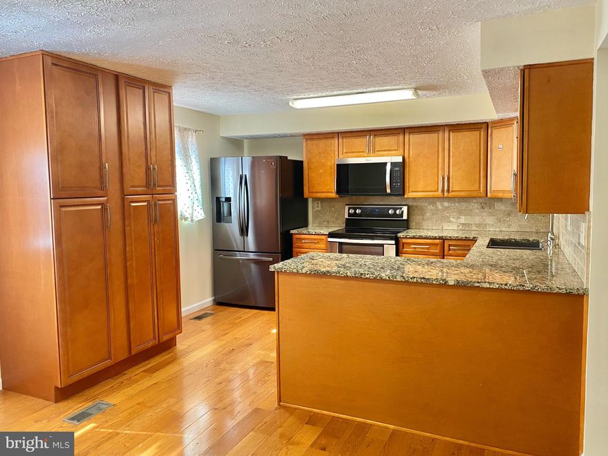 Enjoy the extra yard space this well-cared-for end unit, brick front townhome offers, ideally situated in Howard County and close to I-95. Spend quiet moments in front of the fireplace in the finished lower-level family room or outside on the deck overlooking the fenced backyard. Features a large country kitchen, new carpet, and recent updates to roof, windows, water heater, HVAC, and baths (all less than 5 years old).  Features 3 bedrooms and 3.5 bedrooms.  The community has a neighborhood tot lot.