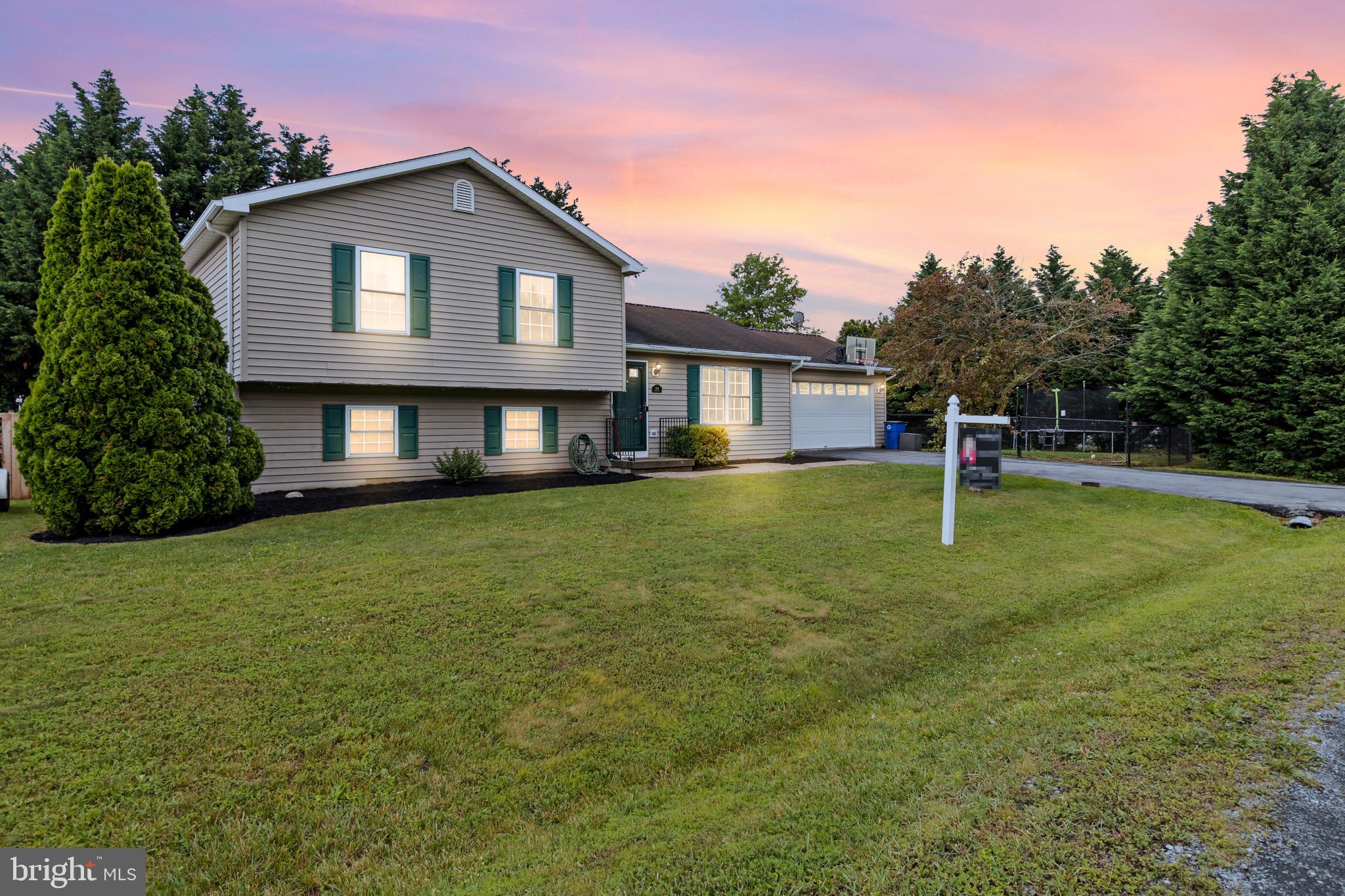 Welcome to this inviting 3-bedroom, 2-bathroom split-level home, perfectly situated on a desirable corner lot. This residence boasts lots of features designed for comfort and convenience, making it an ideal place to call home. Three well-appointed bedrooms offer ample space for family, guests, or a home office, and two full bathrooms. Enjoy the unique layout that offers a seamless flow between living spaces. Perfect for families, pets, or private gatherings, the fenced yard ensures safety and privacy. Step outside to a spacious, lovely deck, ideal for relaxing or entertaining while overlooking the backyard. A versatile finished basement adds additional living space, perfect for a recreation room, office, home gym, 4th bedroom or extra storage. Mature privacy trees surround the property, creating a peaceful and secluded environment. Located in a friendly neighborhood with easy access to schools, parks, shopping, and dining, this home offers the perfect blend of suburban tranquility and modern convenience. Don't miss the opportunity to make this charming property your own! Schedule a showing today and envision the possibilities of life in this beautiful home. The basketball hoop, trampoline, and awning do convey!!