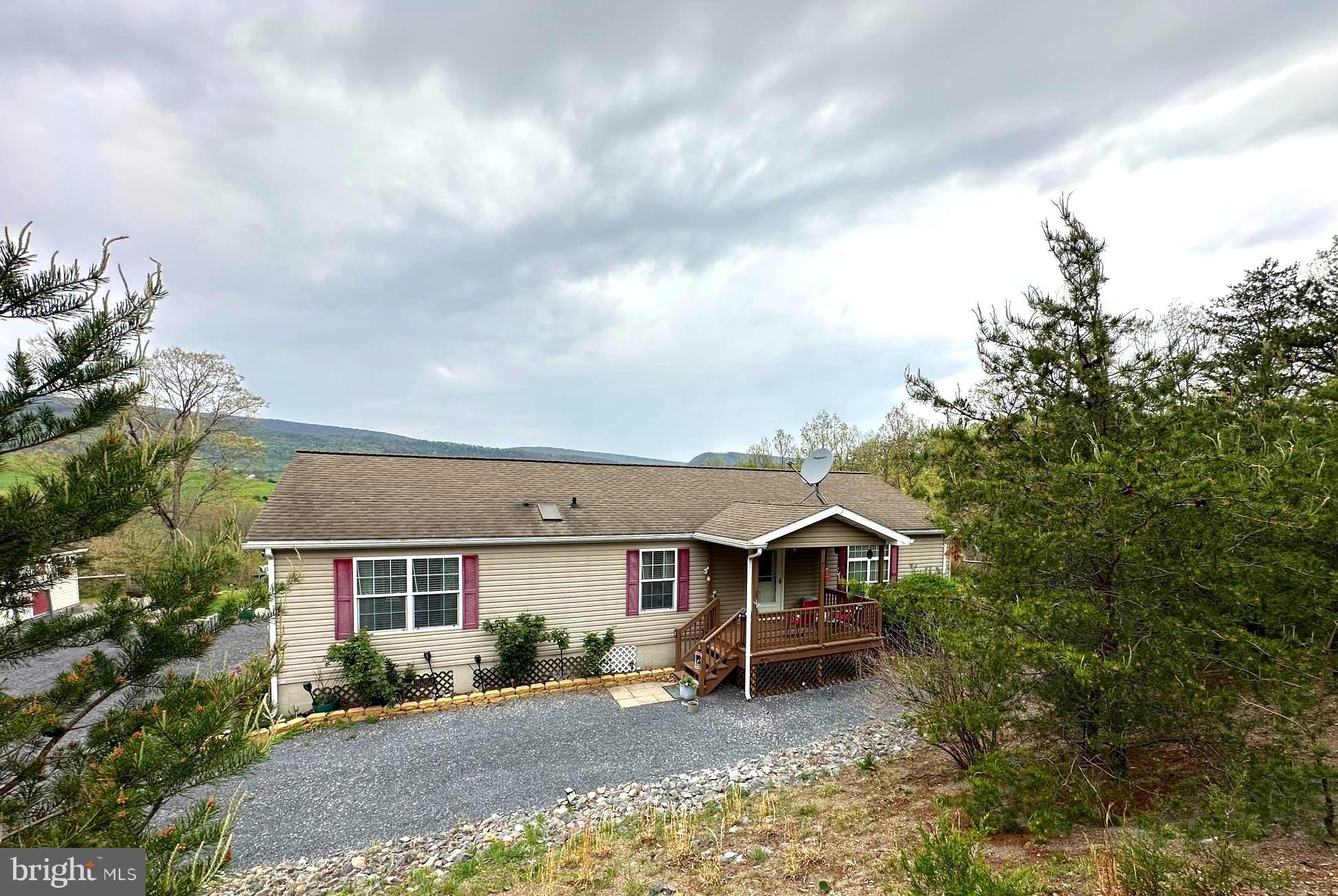 Step into a world where dreams become reality in this enchanting 2025 +/- sq. ft. sanctuary. Tucked away at the end of a no thru street. The VIEWS that captivate you as you enter the driveway are breathtaking. Continue being mesmerized with the VIEWS at the firepit or covered porch.
The heart of the home beats in the expansive, light-filled kitchen, where vaulted ceilings adorned with wooden beams create an airy ambiance. Gleaming wooden cabinets and a mosaic backsplash add a touch of elegance, while the central island invites culinary creativity and casual dining.
The living area exudes comfort and style. The exposed wooden beams create an inviting atmosphere for relaxation and entertainment. Natural light floods through large windows, connecting indoor living with the serenity of the outdoors.
Indulge in the luxurious primary bedroom, a spacious walk in closet adds a touch of grandeur to your personal space. The primary bathroom offers a spa-like experience, with modern fixtures and soothing color palettes that promise relaxation after a long day. Two additional bedrooms and a full bath complete the lodging in the home.
For those who love to entertain, the family room boasts wood-paneled walls with many windows for capturing that unbelievable VIEW is perfect for hosting gatherings or enjoying quiet evenings. Throughout the home, charming details like rustic doors and warm tones create a cohesive, warm aesthetic that speaks to the soul.
Detached carport, 2 sheds and a portable generator convey.
This isn't just a house; it's a canvas for your dreams, a place where every day feels like a retreat. Welcome home to your personal slice of paradise, where comfort meets style, and memories are waiting to be made.