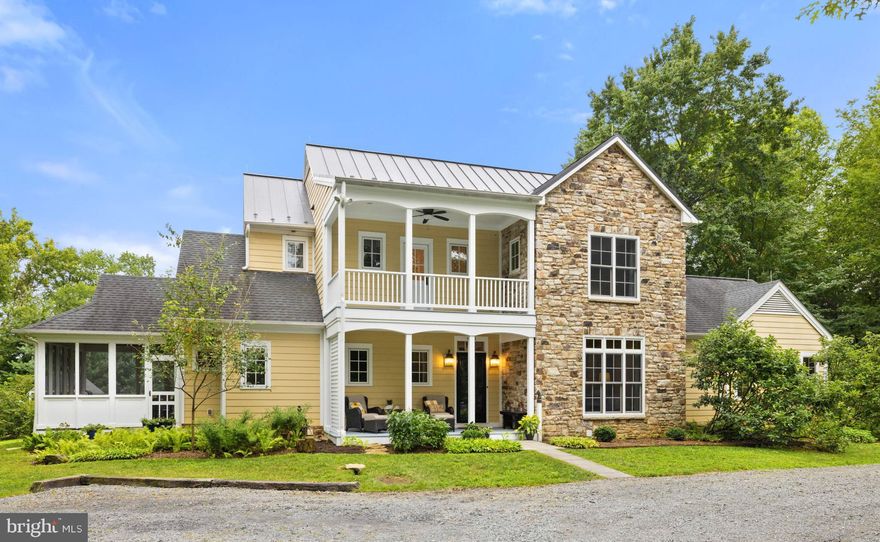 Welcome to Bluebird Haven! Tucked away among mature trees just minutes from the historic village of Middleburg, this beautifully crafted colonial home offers over 5,300 square feet of gracious living space across three levels. Sited for optimal Southern exposure, the home combines timeless charm with sustainable planning, ensuring natural light, privacy and energy efficiency. The floor plan was intentionally designed for comfort and longevity, featuring two spacious primary bedroom suites - one on the main level and one upstairs - ideal for multigenerational living or aging in place. The main level includes wide doorways, a roll-in shower and has been prepped for a future elevator. The home boasts reclaimed oak and chestnut flooring, soaring 9’+ ceilings, Marvin windows and a stunning floor-to-ceiling stone fireplace with a Hearthstone woodstove as the heart of the open living room area. The gourmet kitchen is a chef’s dream, complete with high-end stainless-steel appliances, custom soft-close cabinetry, a walk-in pantry, leathered dark marble countertops, an antique porcelain farm sink and an island with a secondary prep sink. Just off the kitchen, the dining area is illuminated by a striking 3-light Loblolly Goods chandelier, one of two thoughtfully chosen pieces that enhance the home's custom character. Upstairs, a separate laundry room adds practicality, while the lower level offers abundant potential with unfinished spaces designed for a recreation room, home gym, and workshop. It’s also plumbed for a future half bath. Enjoy the outdoors year-round from the screened-in porch, flagstone fire pit area, or amongst the raised garden beds. Additional features include a 2nd story open balcony, chicken coop, built-in play set, garden shed, and barn doors and bathroom vanities handcrafted from oak trees milled right on the property. From concept to construction, this home was designed with purpose, comfort and attention to detail. Move right in and enjoy the best of hunt country living with the convenience of town just minutes away.