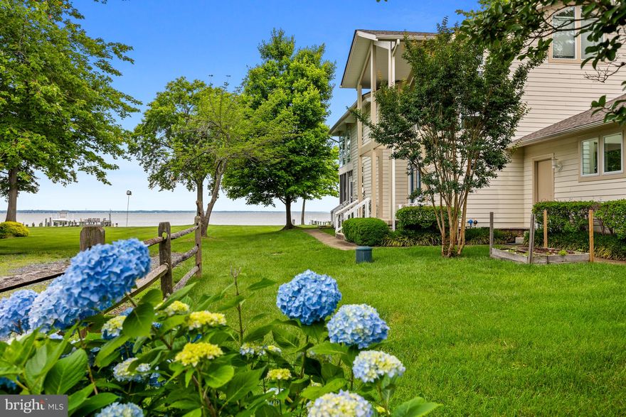This is your ultimate Chesapeake Bay getaway! Discover ideal waterfront living with this meticulously maintained property offering the most stunning views of the Chesapeake Bay. Located in the desirable community of Holland Point in North Beach, this is a special place! 
Holland Point offers a unique 1.3-mile-long grass walk along the bay-facing portion, perfect for leisurely water view strolls.  Just a short walk or bike ride away, is Herrington Harbour resort including a marina (with overnight boat parking for your guests that want to arrive via boat!), swimming pool (waitlist for membership), and public restaurant, Ketch 22! A local market offers any conveniences you may need, as well as breakfast and lunch!
Chesapeake Beach, a quick drive away, features a beach, waterpark, and a variety of local restaurants and shops. 
From everyday living to entertaining guests, this home’s thoughtful layout and spacious design cater to all your needs. Enter the home through the covered front porch to the stunning two-story foyer with vaulted ceiling and beautiful windows. The main level features an ideal open floor including large living room with gas fireplace, separate dining area and gourmet kitchen, all with stunning water views. The kitchen features abundant cabinetry, stainless steel appliances, tile backsplash and large walk-in pantry. 
Step onto the waterside screened-in porch for a delightful meal or simply unwind while soaking in the bay breeze and the soothing sounds of the water. This exceptionally well-built home boasts exposed beams, vaulted ceilings, large overhangs, and low-maintenance materials like HardiPlank siding. A 24kW whole-house generator ensures seamless living, no matter the weather.
Also on the main level is a bedroom and full bathroom, ideal for guests or one floor living. There is also two car garage with ample storage!
On the upper level, the expansive waterside primary suite features stunning bay views, an en-suite bathroom and a double-sided fireplace that connects to a primary office or studio. Two additional large bedrooms, a full bath, laundry closet, and a versatile nursery/office complete the upper level, offering ample space for family and guests.
Enjoy direct access to the water with your private pier, offering 3+ MLW depth, boat lift, fish cleaning station and plenty of space for outdoor furniture to savor the bay views. The community-owned lot next door guarantees privacy and additional green space, with no future construction to obstruct your views.
Located less than an hour from DC and Baltimore, and a short distance to Annapolis, 750 Bay Front Avenue provides the perfect blend of tranquility and accessibility. Experience the ultimate in waterfront living at 750 Bay Front Avenue – your dream escape awaits!