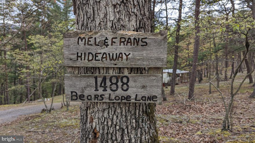 New price!  This would make a perfect hunting camp and hunting season is just around the corner. A place one can truly relax, breathe deeply, and reconnect with the simple joys of life.  Nestled in the mountains of West Virginia, the single wide mobile home sits quietly among nature.  The home, modest yet cozy features a study deck that offers panoramic views of all nature has to offer. Inside a natural stone hearth surrounds the wood stove. Some furnishings will remain, and property is being offered "as-is". No HOA, light deed restrictions, $25/year road maintenance. Located just minutes down the road from the Cacapon River for floating, fishing and swimming. Easy access to hospital, grocery, restaurants, and more. Enjoy antique shops, and short trips to the Cacapon Resort State Park, take a historic walk at Prospect Peak and so much more.  Perfect as hunting cabin, weekend escape or seasonal vacation spot. or even year round living.  ATV's, shooting and hunting are allowed.