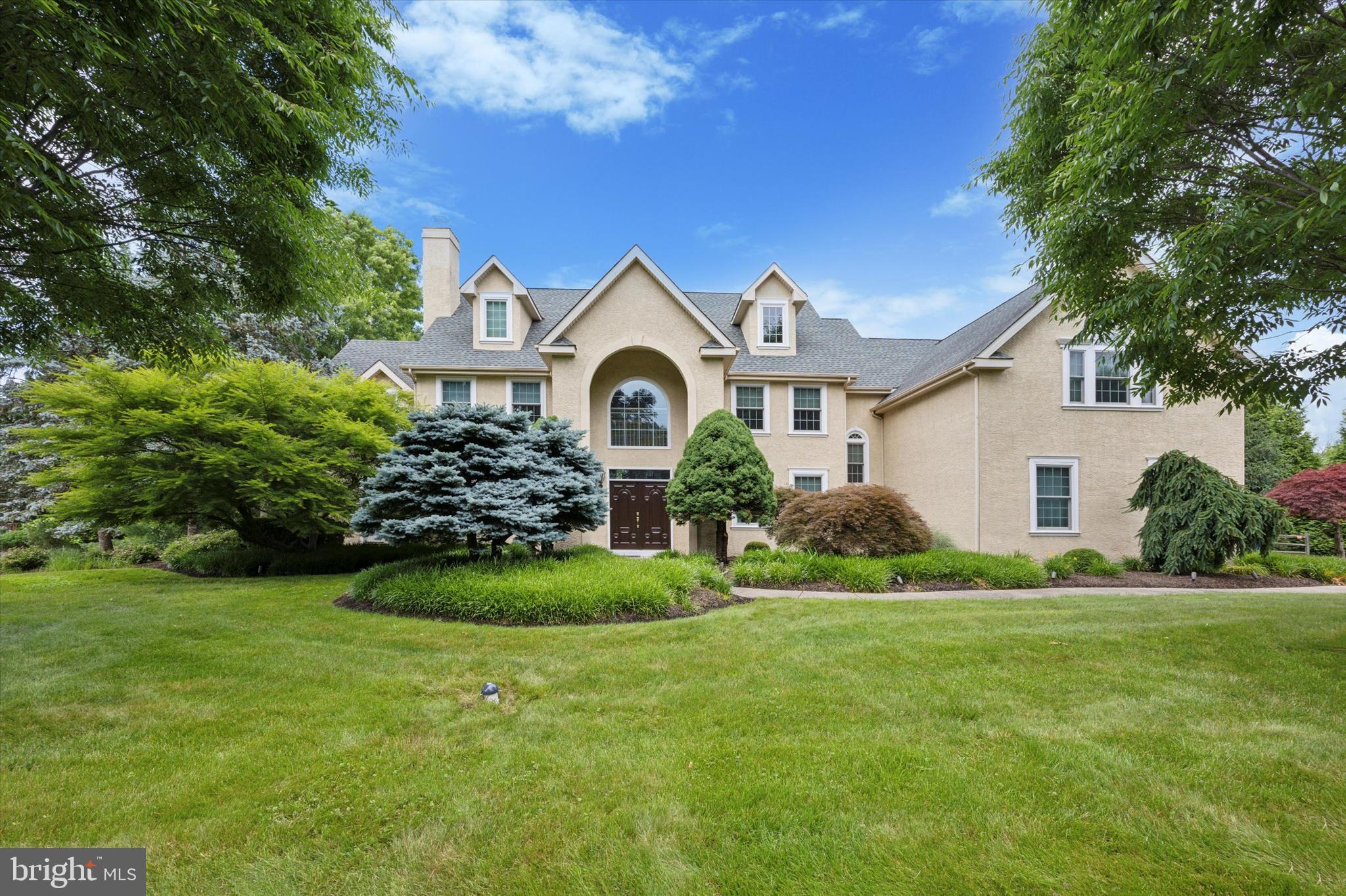 Welcome to this stately colonial home, nestled in the serene beauty of Hillcrest Meadows in Worcester Township and set on over 4.5 lush acres, The former model is a masterpiece of elegance and functionality, offering an unparalleled living experience.
As you enter through the grand two-story foyer, you will be captivated by the exquisite millwork and sweeping curved staircase. The spacious formal living and dining rooms exude sophistication, complemented by a convenient butler's pantry leading to a chef's dream kitchen. Outfitted with Viking appliances, upgraded cabinetry, a large granite center island, two-tone granite countertops, and a stunning Palladian window, the kitchen is the heart of this home. An expanded breakfast area with sliding glass doors opens to a maintenance-free deck, perfect for enjoying morning coffee or evening sunsets.
The inviting family room features an 18-foot cathedral ceiling, a built-in entertainment center, a gas fireplace, and a wet bar, creating a cozy yet luxurious gathering space. Completing the main level are a private office, a cozy sunroom off the living room offering French doors to the side patio, a powder room, and a versatile laundry room with access to the kitchen, garage, and driveway.
Upstairs, the curved oak staircase leads to an extra-wide hall and balcony overlooking the foyer and family room. The double-door entry opens to a sumptuous primary suite, a true retreat with a private sitting area, vaulted ceiling, gas fireplace, two walk-in closets, and a spa-like bathroom featuring a jetted soaking tub, stall shower, and dual vanities. A private bedroom suite with a full bathroom, two additional bedrooms, a shared hall bathroom, and an office/homework room with built-ins complete this level. The walk-up attic is ready to be finished to suit your needs.
The finished basement is an entertainer's dream, offering a wine cellar, kitchenette with sit-up peninsula, a half bath, and a walkout to the pool area. Oversized 3 car attached garage fully customized by Garage Tek. Outdoors, you will find a built-in pool and spa surrounded by immaculate landscaping, creating a private oasis for relaxation and recreation. Great Location in Methacton School District. Convenient to shopping, dining, parks, Merck and major routes. Don’t miss the opportunity to own this exceptional property. Schedule your private tour today and experience the charm and luxury of this beautiful home.